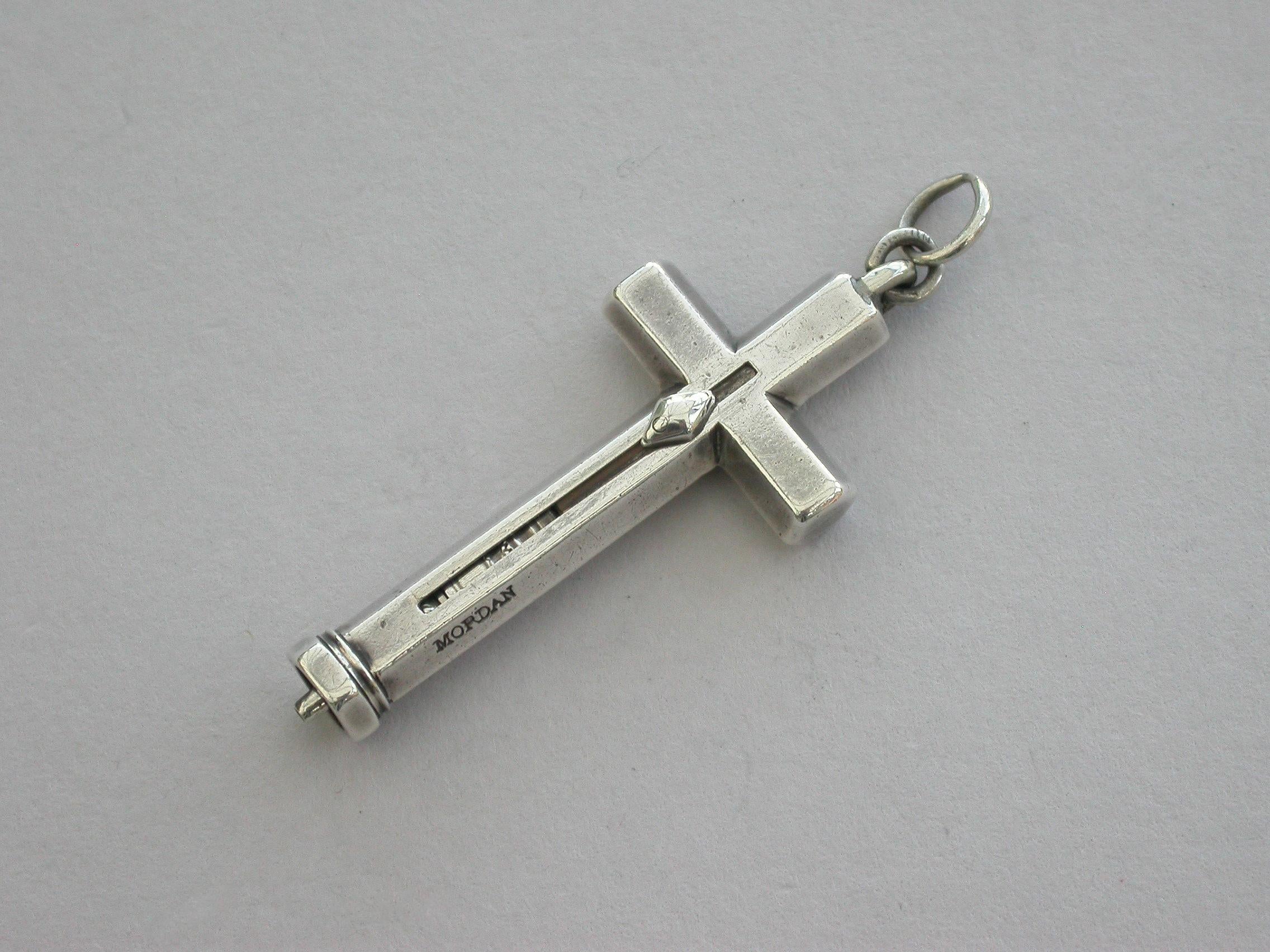 A Victorian novelty silver sliding propelling pencil made in the form of a crucifix, of hexagonal section with diamond shaped slider button and attached suspension ring.

Stamped: 'Mordan' (no S) and with a diamond registration mark for