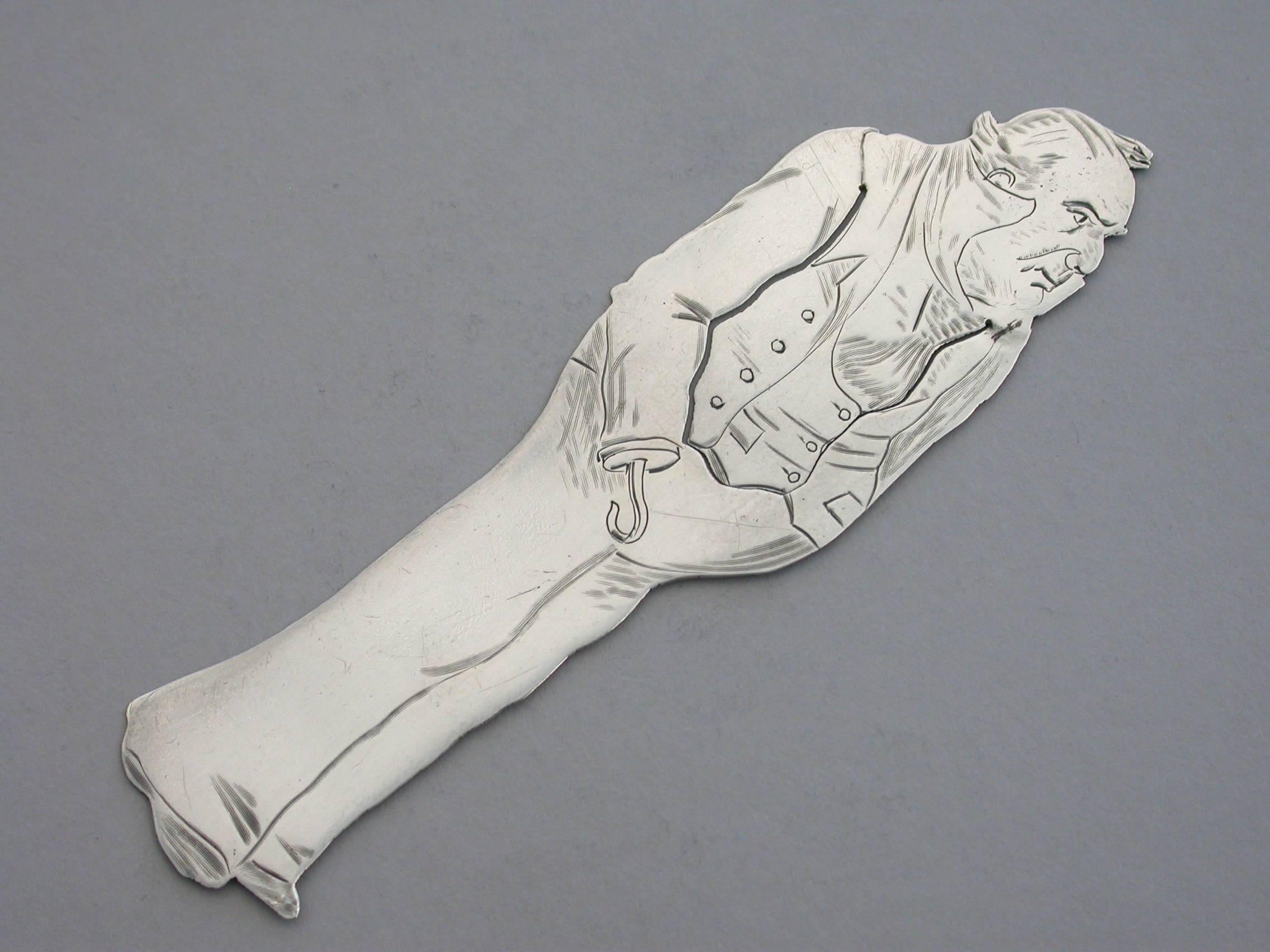 A rare Victorian novelty silver figural bookmark depicting the character of Captain Cuttle from Charles Dickens's novel 'Domby & Son', of flat cut-out form with engraved decoration depicting the Captain in his blue coat with a hook instead of his