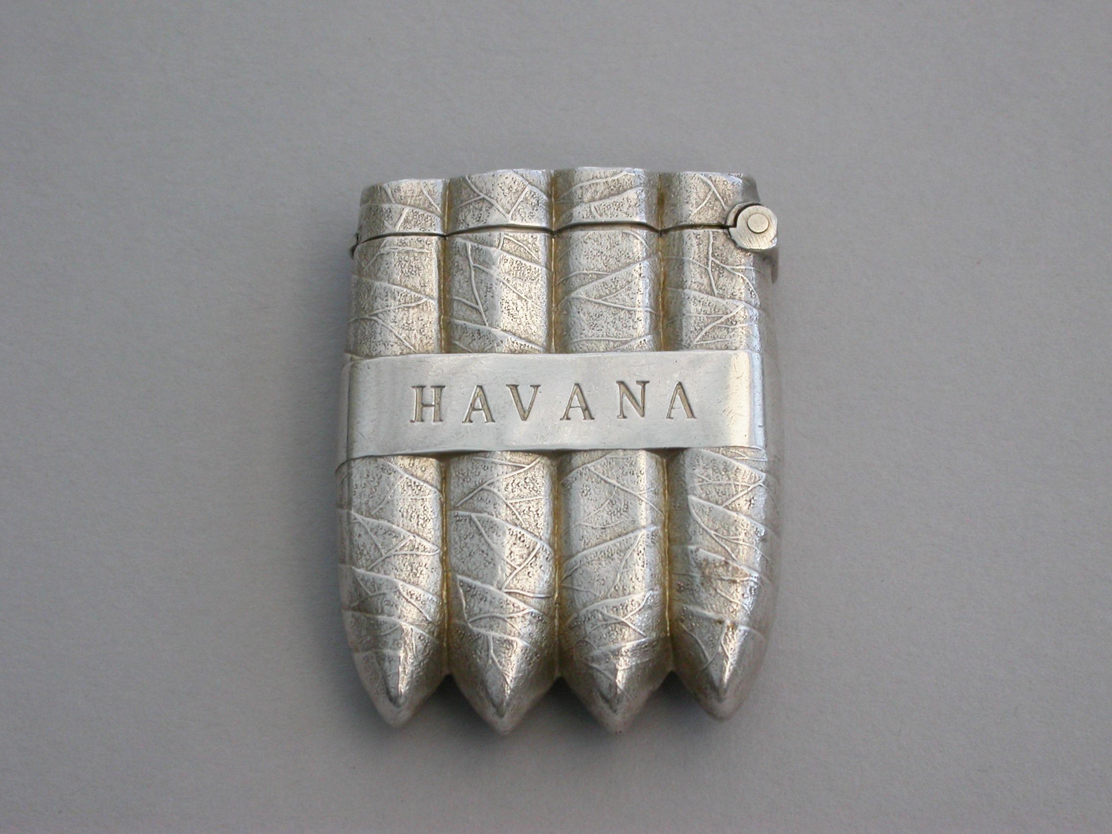 A fine quality Victorian novelty silver Vesta case, naturalistically formed as a bunch of four Havana Cigars, the retaining band engraved 'Havana' on both sides, with hinged flip top lid complete with striker.

By William Neale, Birmingham,