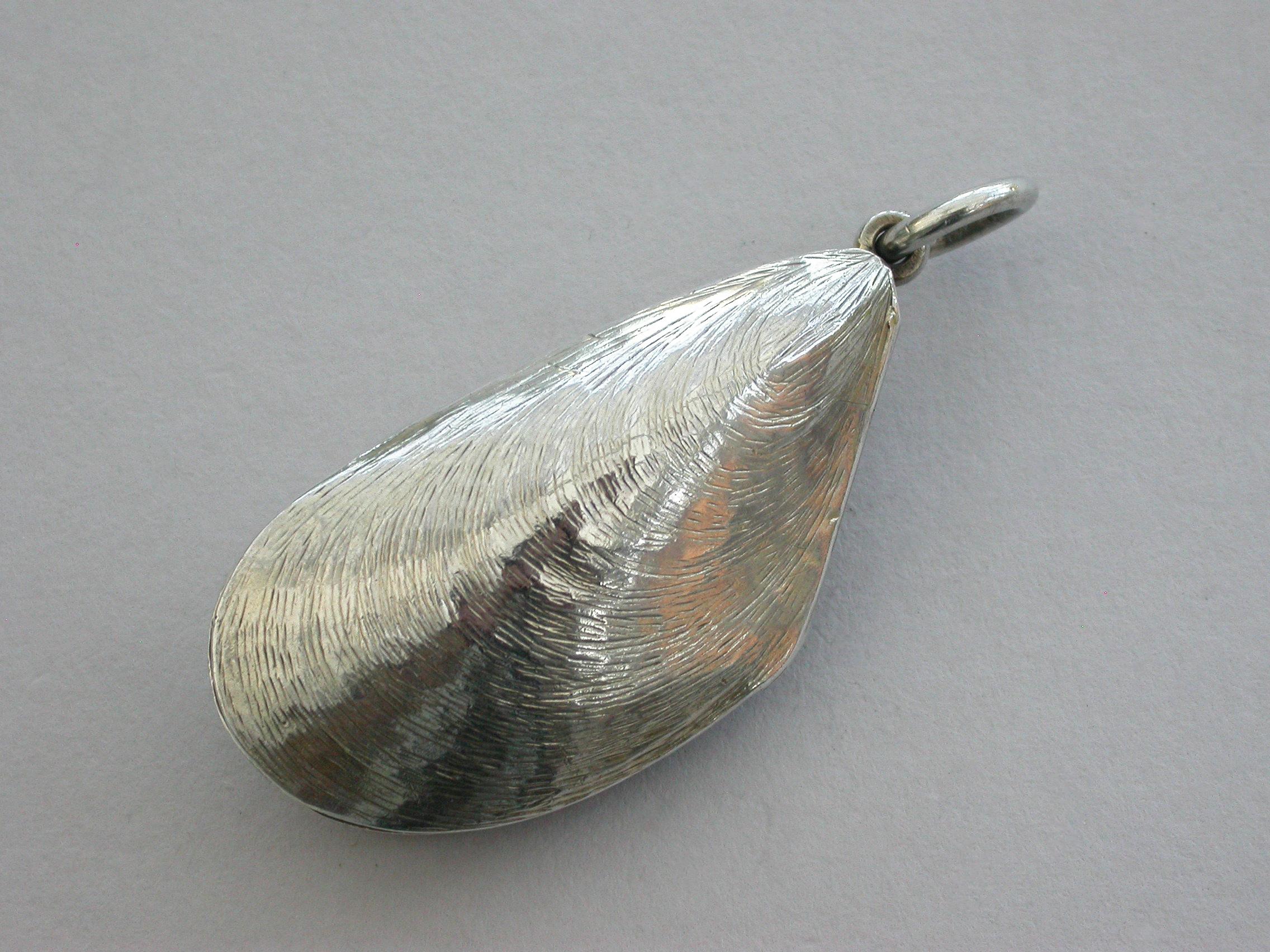 An extremely fine and rare novelty silver Vinaigrette formed as a mussel shell, with a naturalistically engraved exterior, the silver gilt interior with elaborately pierced grille engraved with the maker's name and a diamond registration mark.