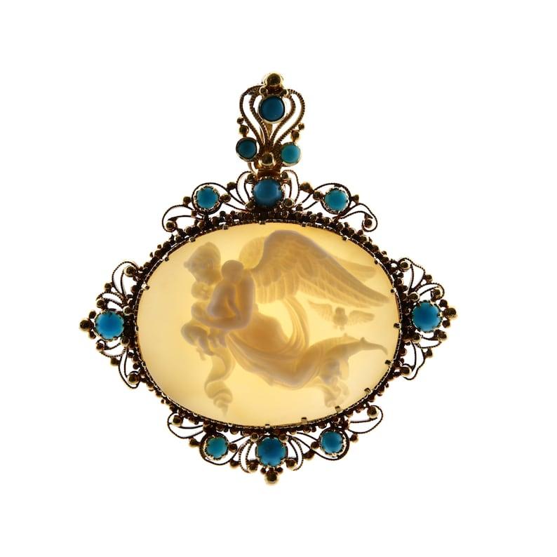 Aston Estate Jewelry Presents:

A mid 19th century Italian carved cameo and turquoise pendant depicting Nyx Goddess of Night after Bertel Thorvaldsen's artwork.

Centered by a finely carved oval cameo plaque set in a gold wire work frame