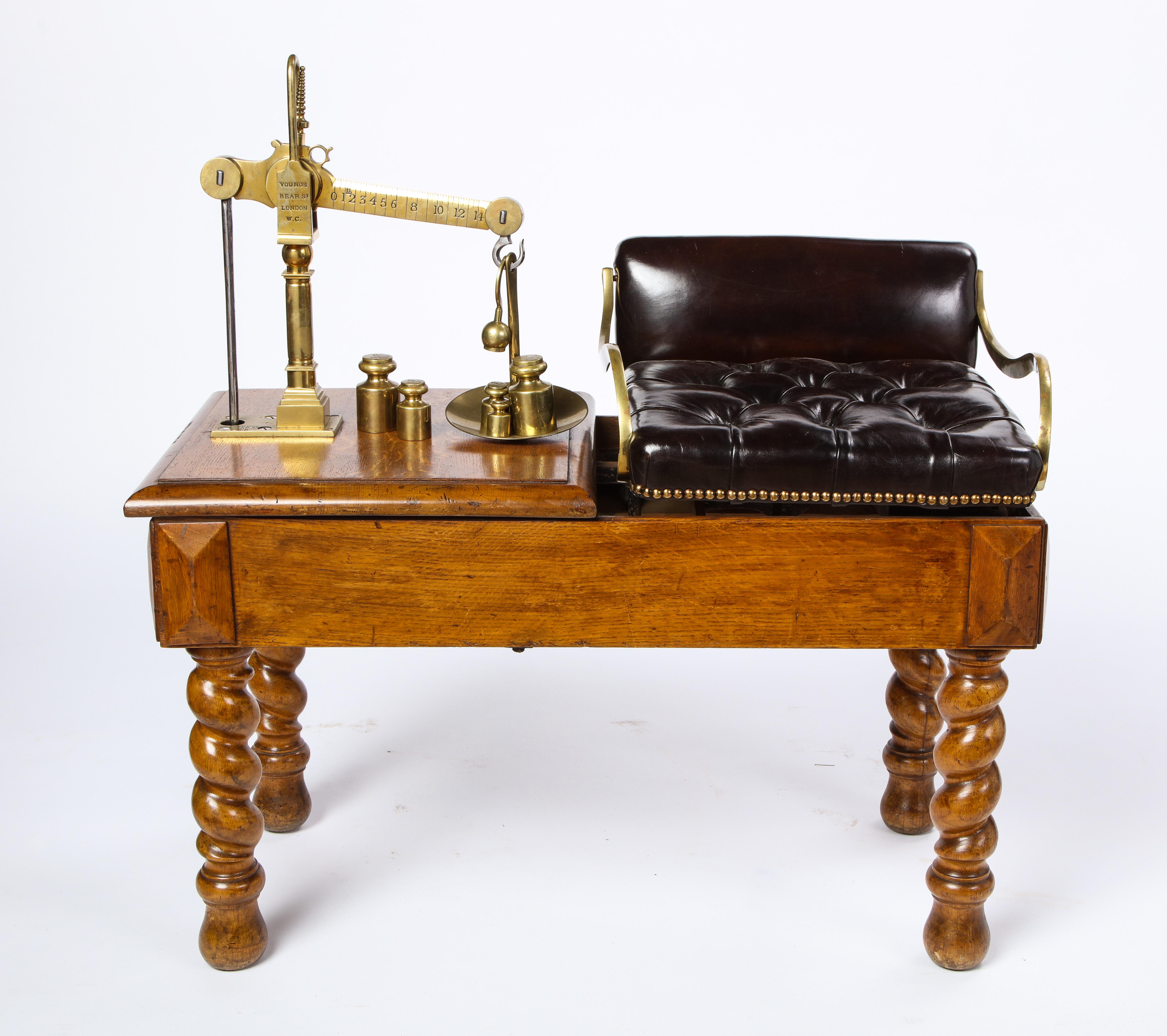 Victorian oak, brass and leather-upholstered jockey scale, late 19th century. The scale signed YOUNGS / BEARST / LONDON / W.C, raised on turned legs.

With a clean, complete well-maintained appearance, structurally sound and ready to use. With
