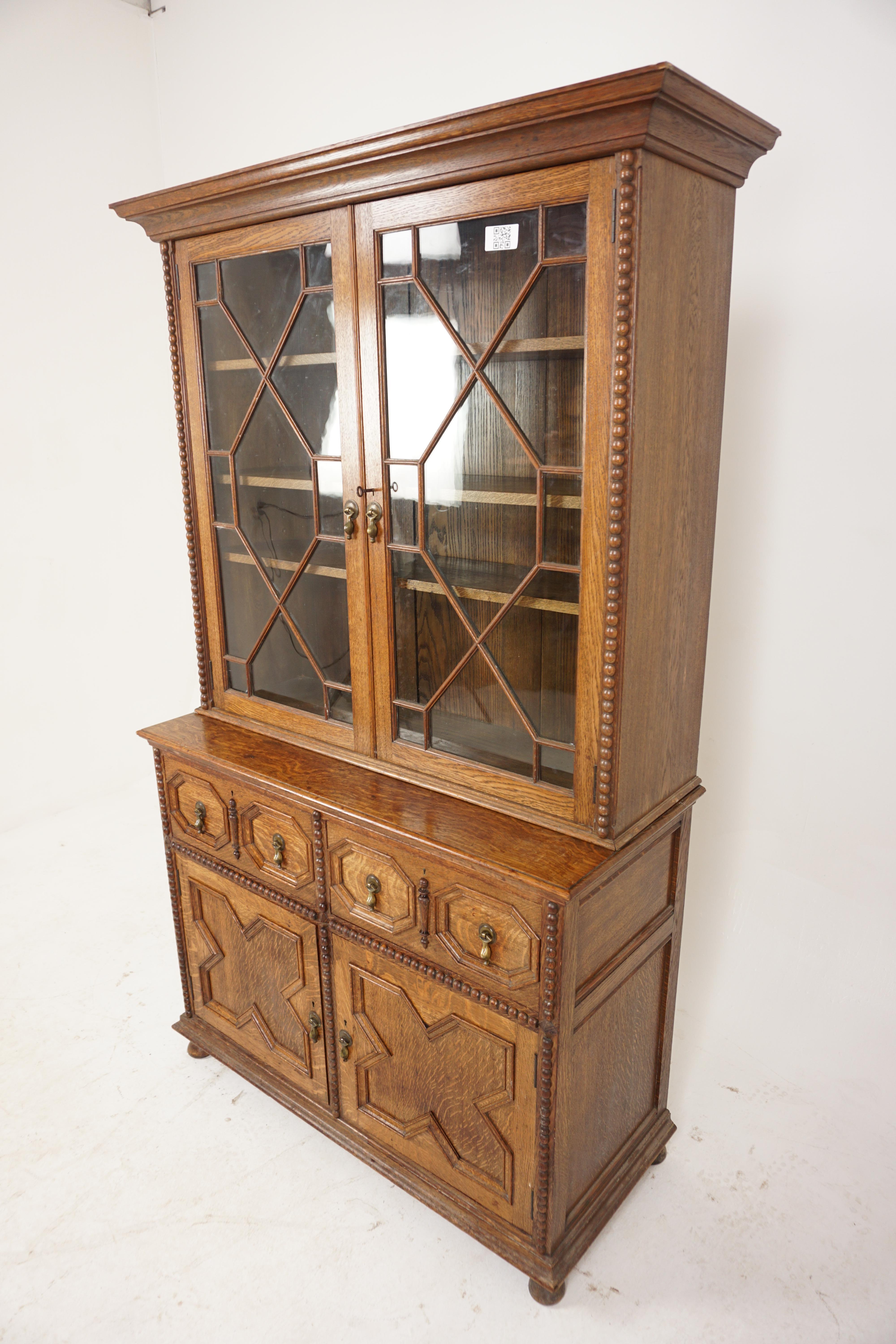 Antique Victorian Oak Cabinet Bookcase, Display Cabinet, “John Taylor Edinburg”, Scotland 1890, H961

Scotland 1890
Solid Oak
Original Finish
Moulded Cornice on Top
Pair of astragal with thirteen panes of glass.
Molding on the doors
Open to