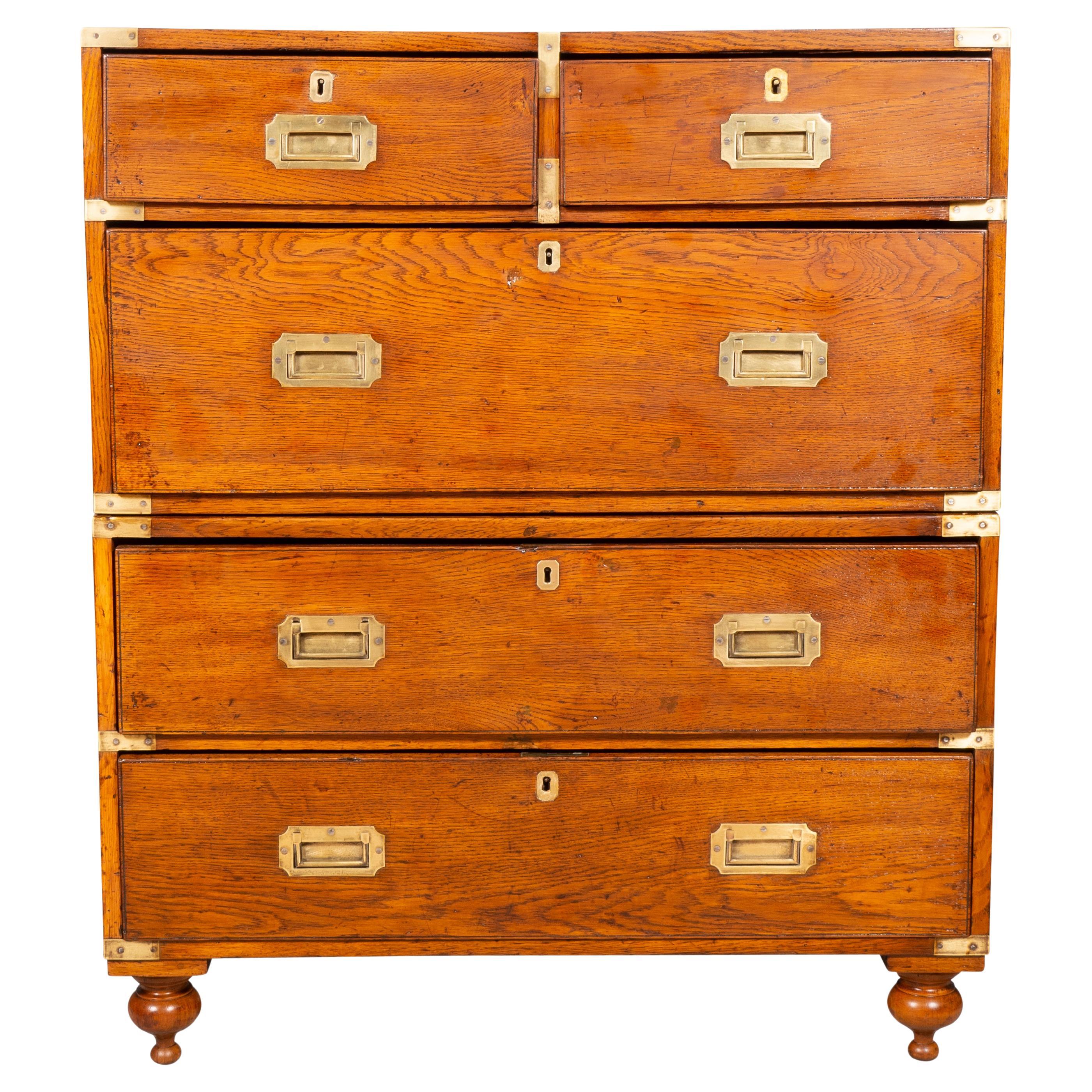 With rectangular top with brass corners over a pair of drawers over three drawers. Toupie feet. Gloucester Ma estate. In two parts. Original recessed brass handles.