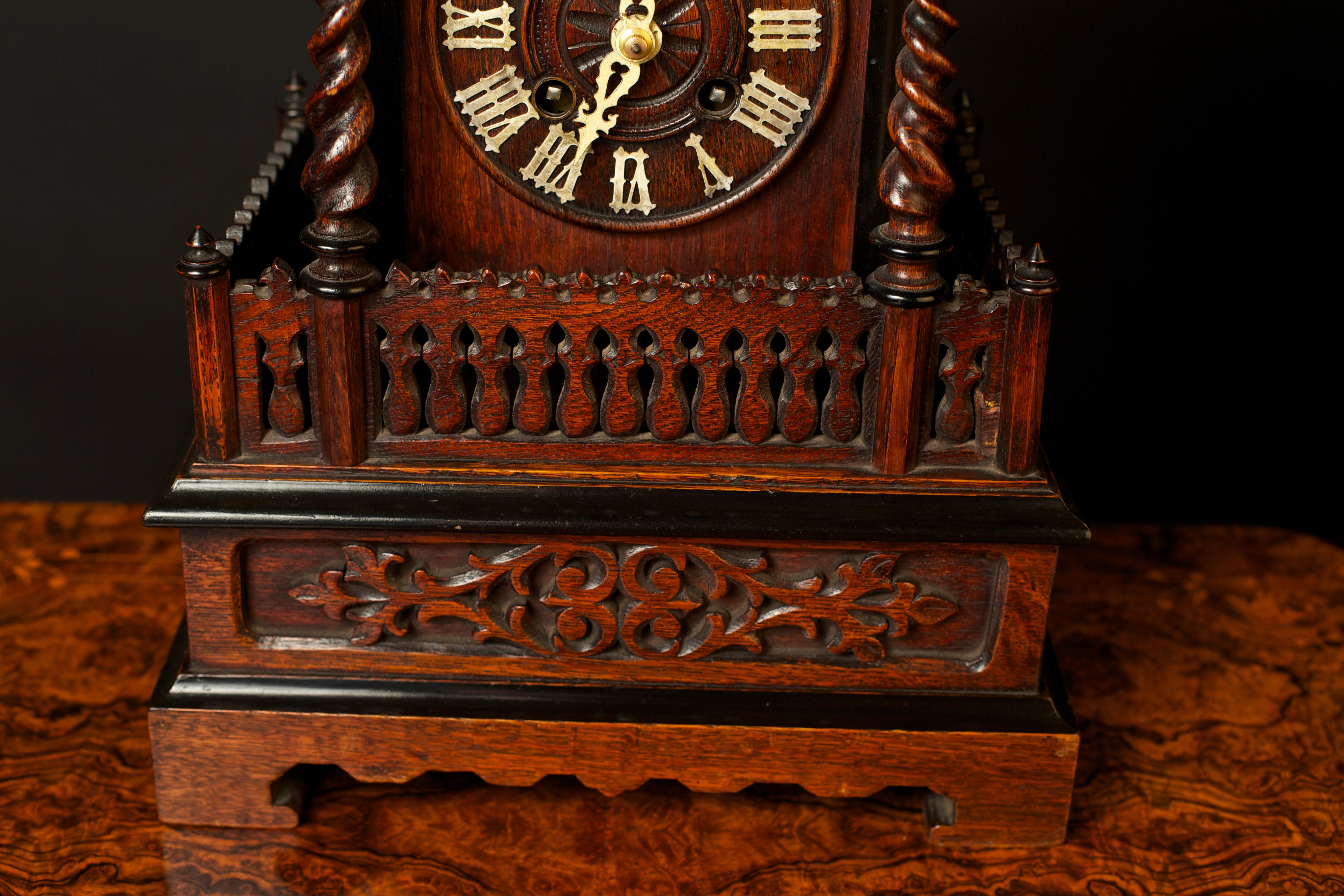 Victorian Cuckoo mantel (fireplace) clock in a chalet style oak case with galleried front and barley twist support columns. Beautifully carved decoration and Roman numerals to the dial. 

Brass thirty hour movement with Cuckoo automation striking