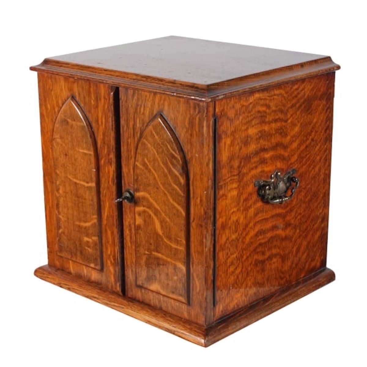 Victorian oak collector's cabinet.

A late 19th century Victorian oak two door collector's cabinet.

The cabinet doors are decorated with a pair of raised Gothic arch panels and has a pair of brass carrying handles.

The cabinet has four