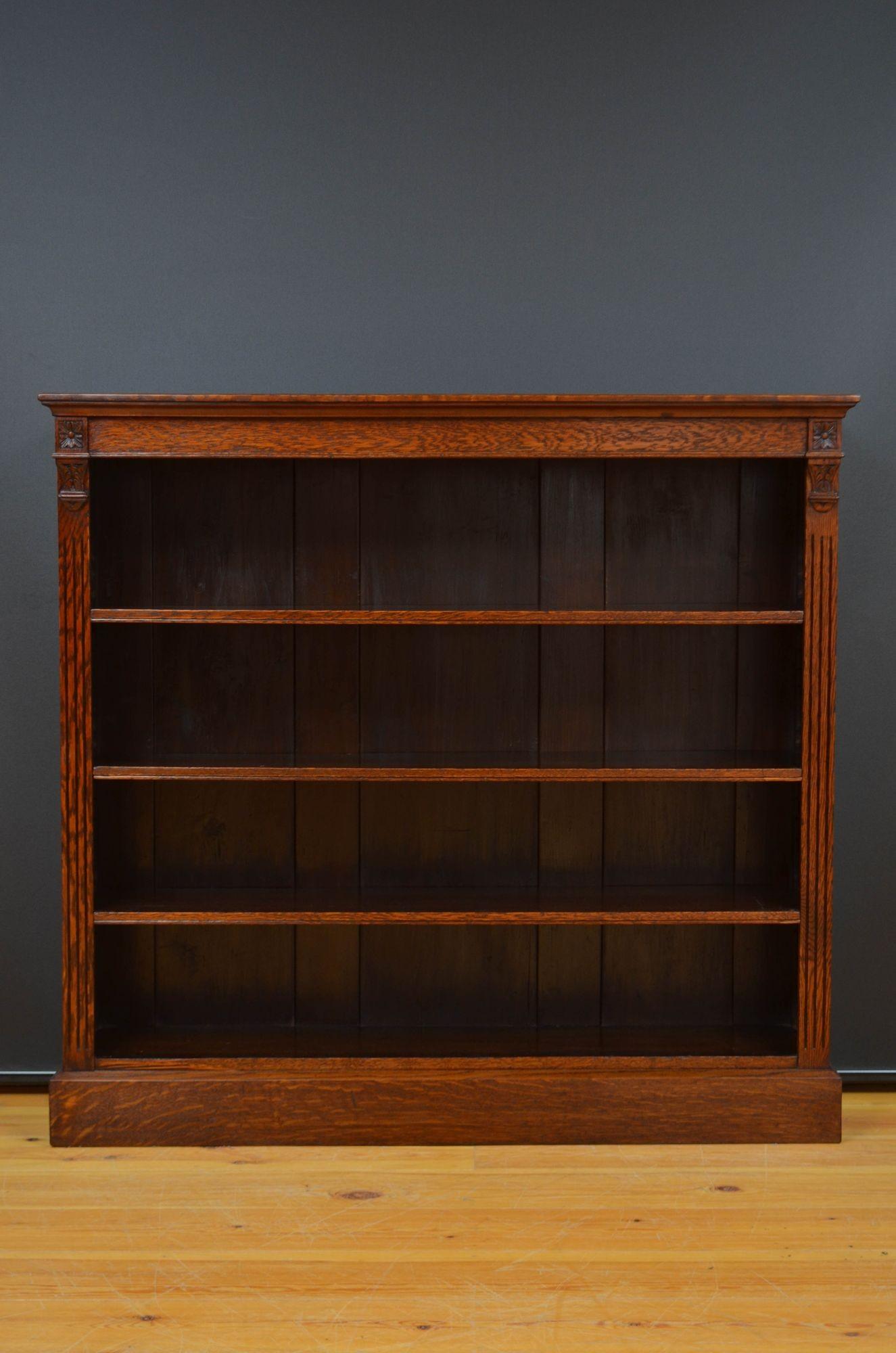 ST053 Libreria vittoriana a giorno, con piano in rovere scuro e ricco, con lesene e intagli a goccia, con tre ripiani regolabili, il tutto su una base a plinto.
H44 3/4