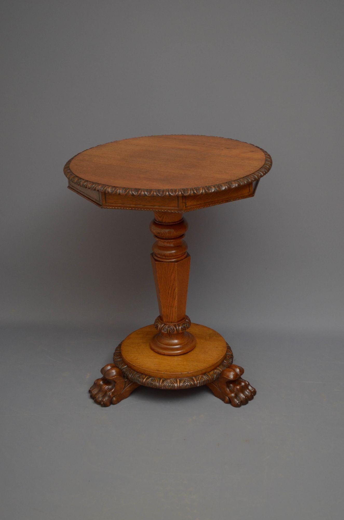 A03 Unusual Victorian pedestal table in oak, having octagonal top with carved edge, standing on turned and flat faceted column terminating in circular base with carved decoration and three paw feet. This antique table is in home ready condition.