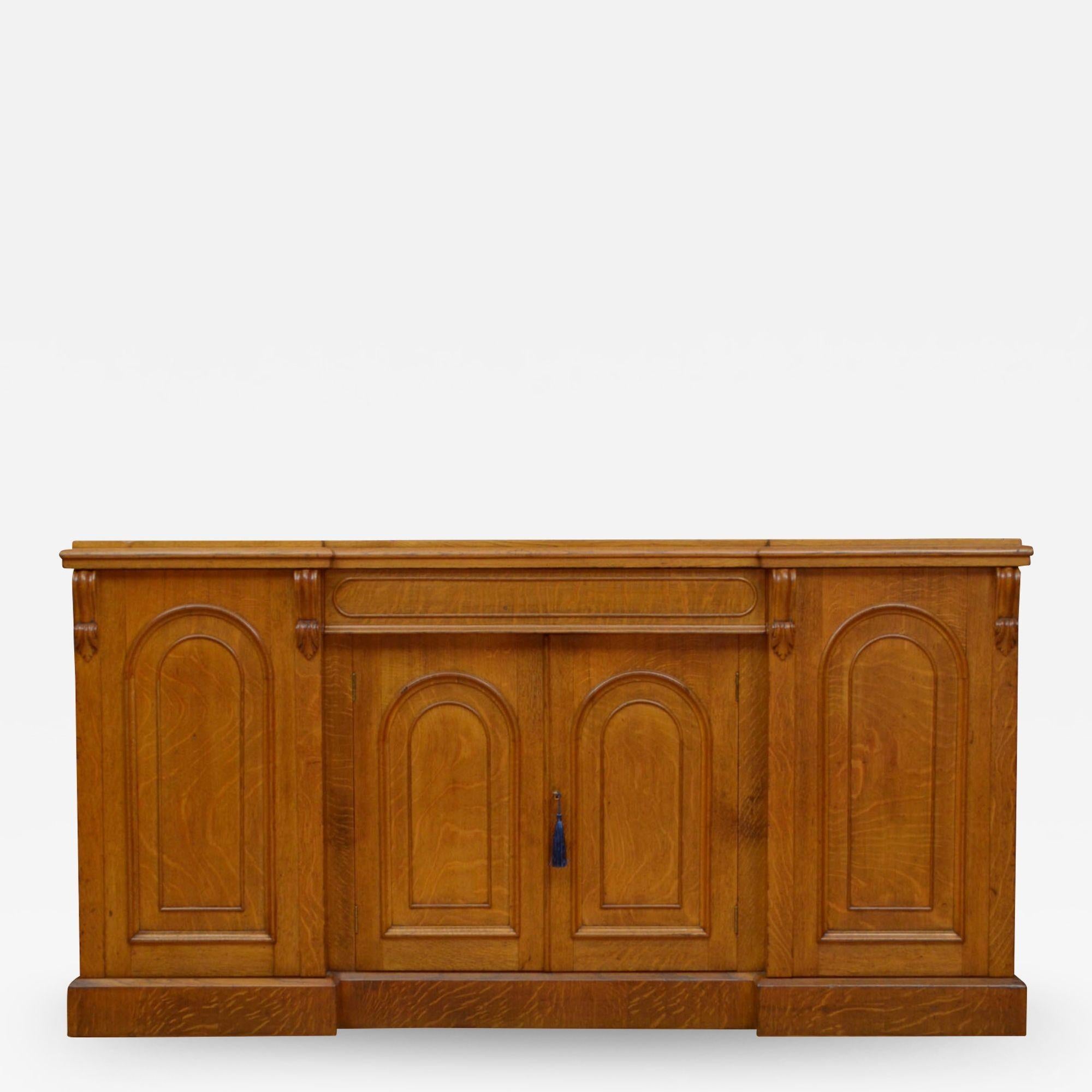 Sn5015 Rare Victorian inverted break front sideboard in oak, having attractive top with moulded edge above central drawer and a pair of arched and panelled cupboard door fitted with working lock and a key and enclosing a shelf, all flanked by