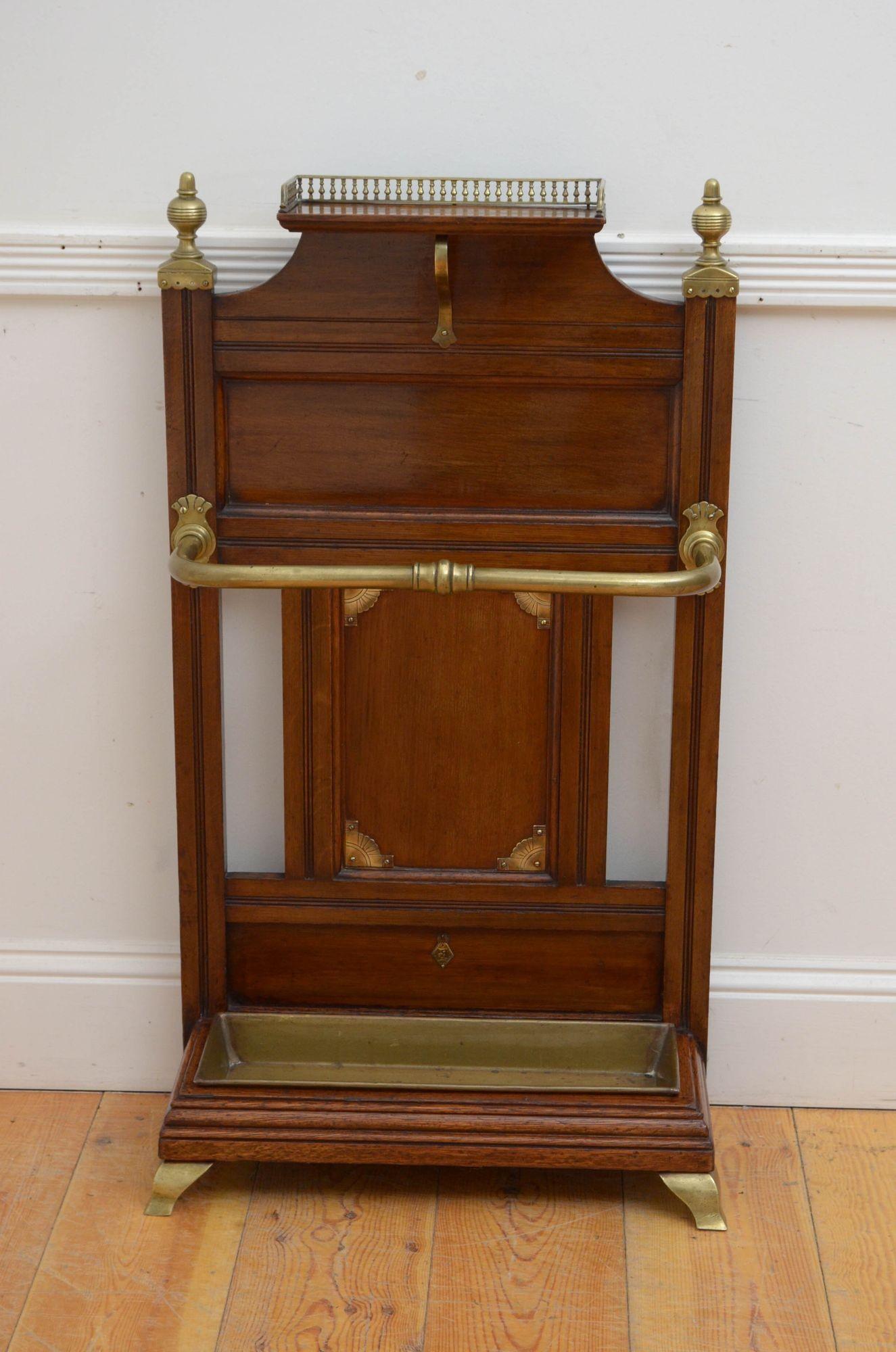 Sn5511 Stylish Victorian, oak umbrella stand in the manner of James Shoolbred, having brass gallery to the shelf over moulded recessed panels and reeded uprights all fitted with decorative brasses, the base having original drip tray, standing on