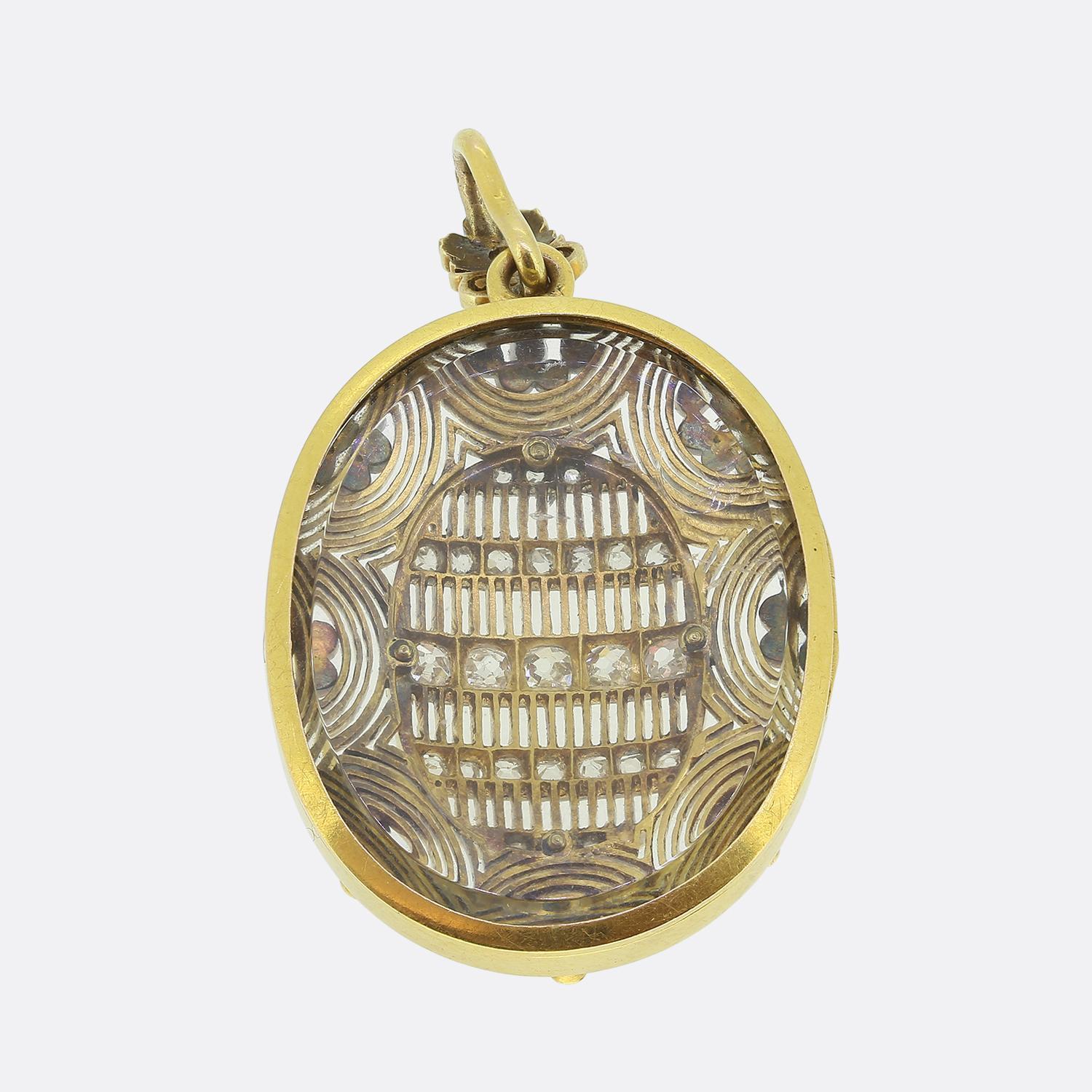 Here we have a fabulous oversized locket pendant taken from the Victorian era. This antique piece features an intricate pierced lattice design adorned with shimmering old and rose-cut diamonds set in a luxurious yellow gold oval motif. The pendant