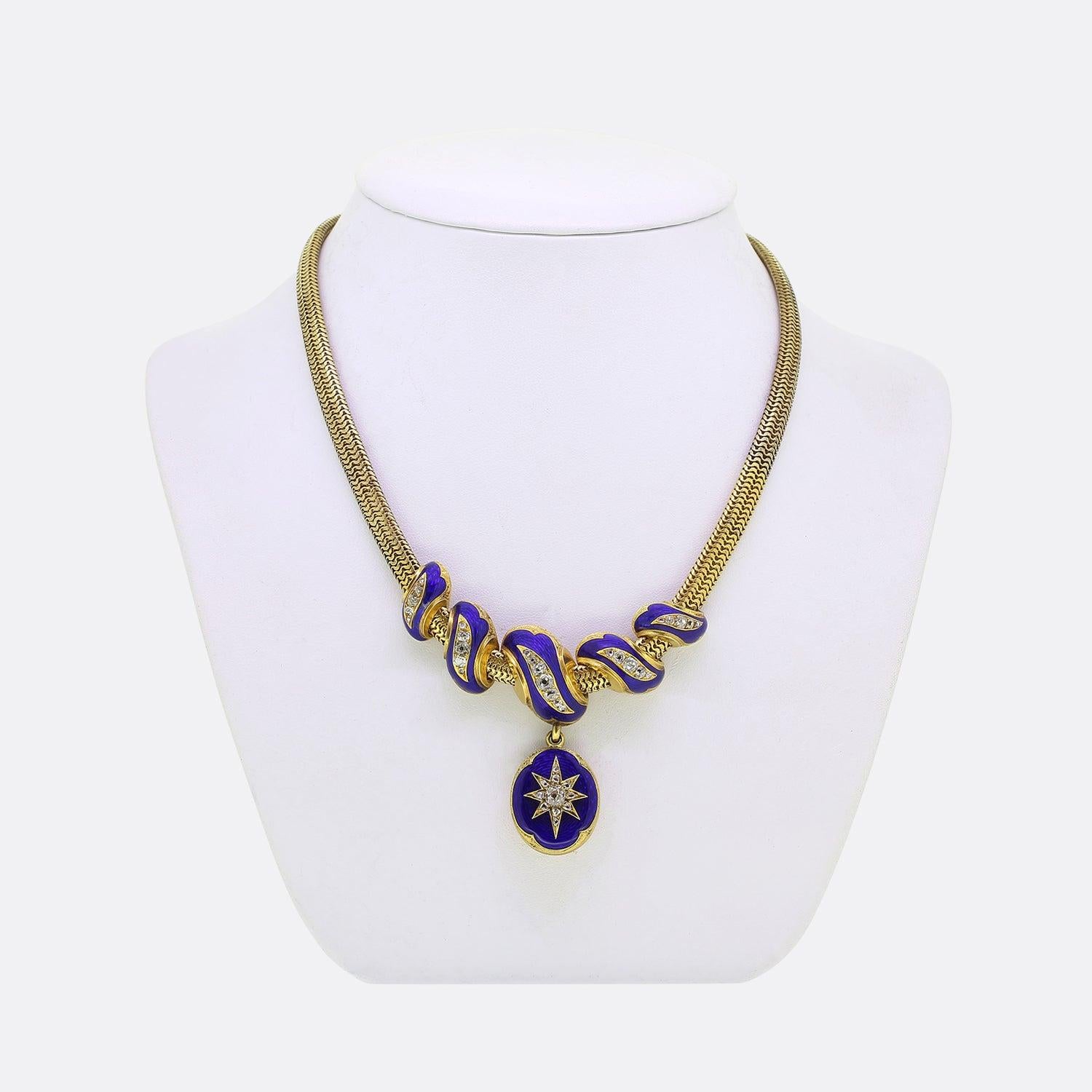 This is a truly wonderful statement necklace from the Victorian era. Suspended from a wide pierced 15ct yellow gold snake chain we find a quintuplet of individual swirling motifs which have been threaded through the centre and hang fixed at the