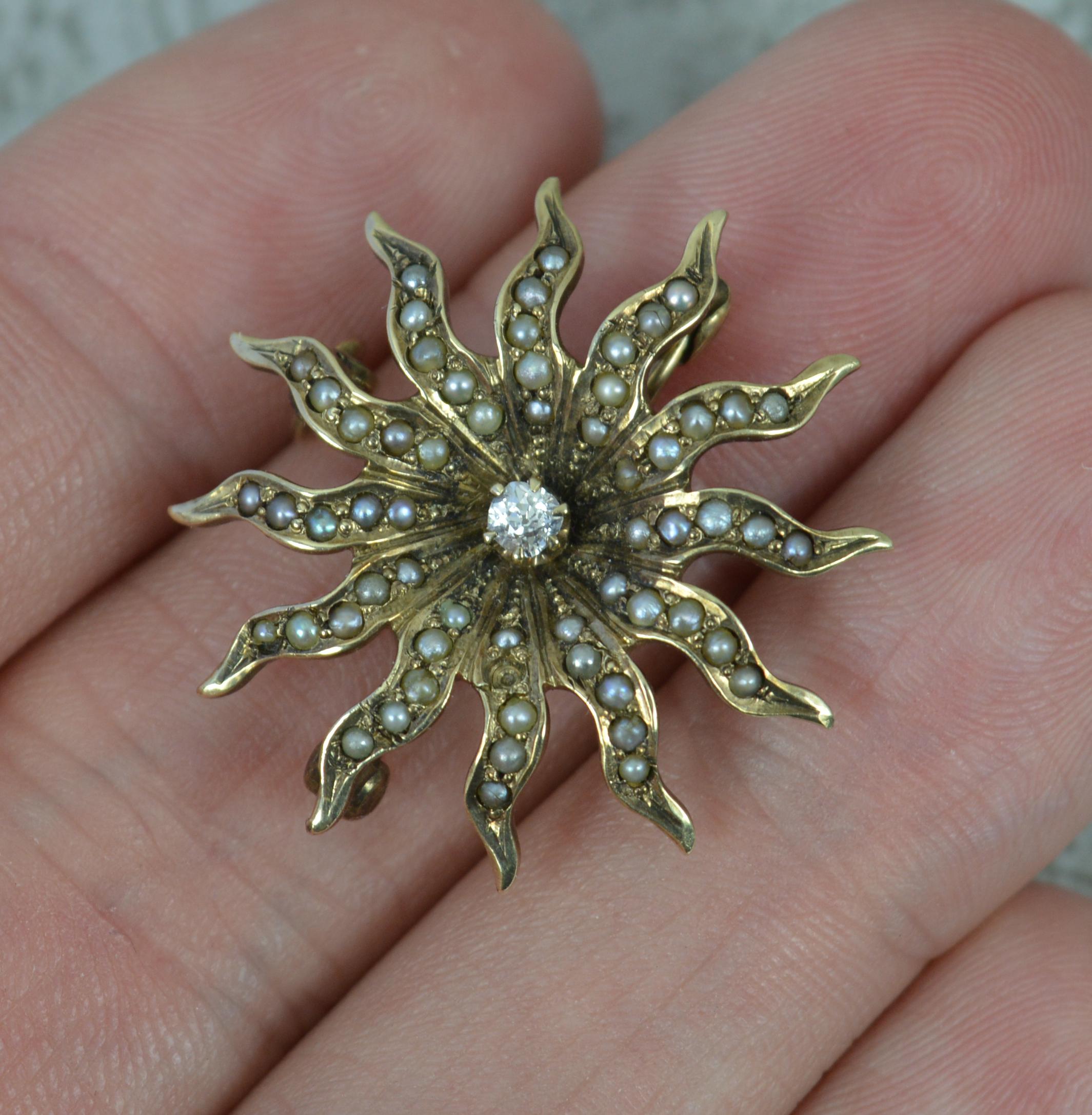 A fantastic brooch.
Solid 9 carat gold example.
Designed as a twelve pointed star or sun.
Set with an old cut diamond to the centre and seed pearls surrounding.

CONDITION ; Very good. Crisp gold section, issue free. Clean stones, well set. Light