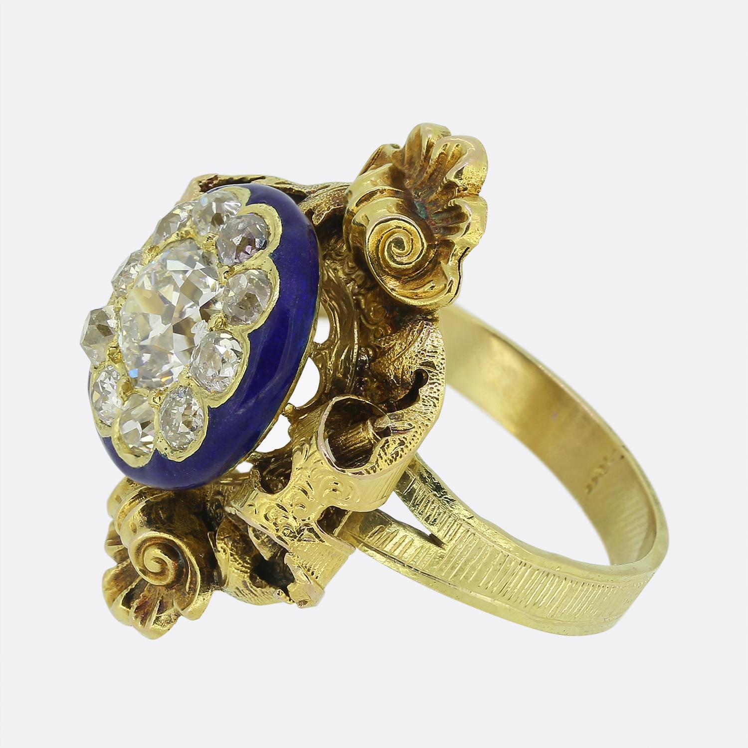 Here we have a remarkable dress ring taken from the Victorian era. This exquisite piece features a centralised old mine cut diamond, radiating a pristine white hue whilst being encircling by a halo of smaller matching stone; all of which sit proud