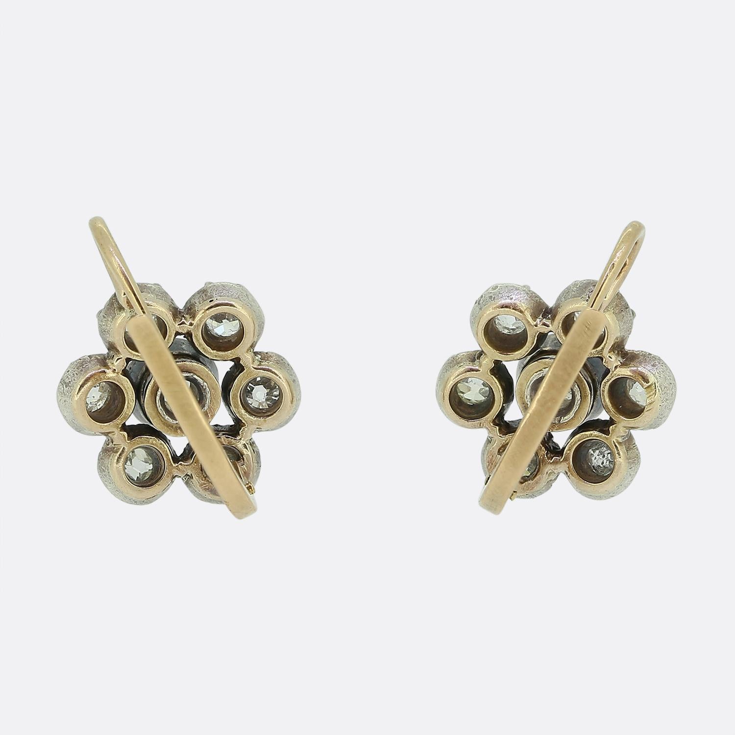 Here we have a delightful pair of drop diamond cluster earrings dating back to the Victorian era. Each piece features an array of round faceted old mine cut diamonds; each of which has been individually collet-set in silver to collectively form a