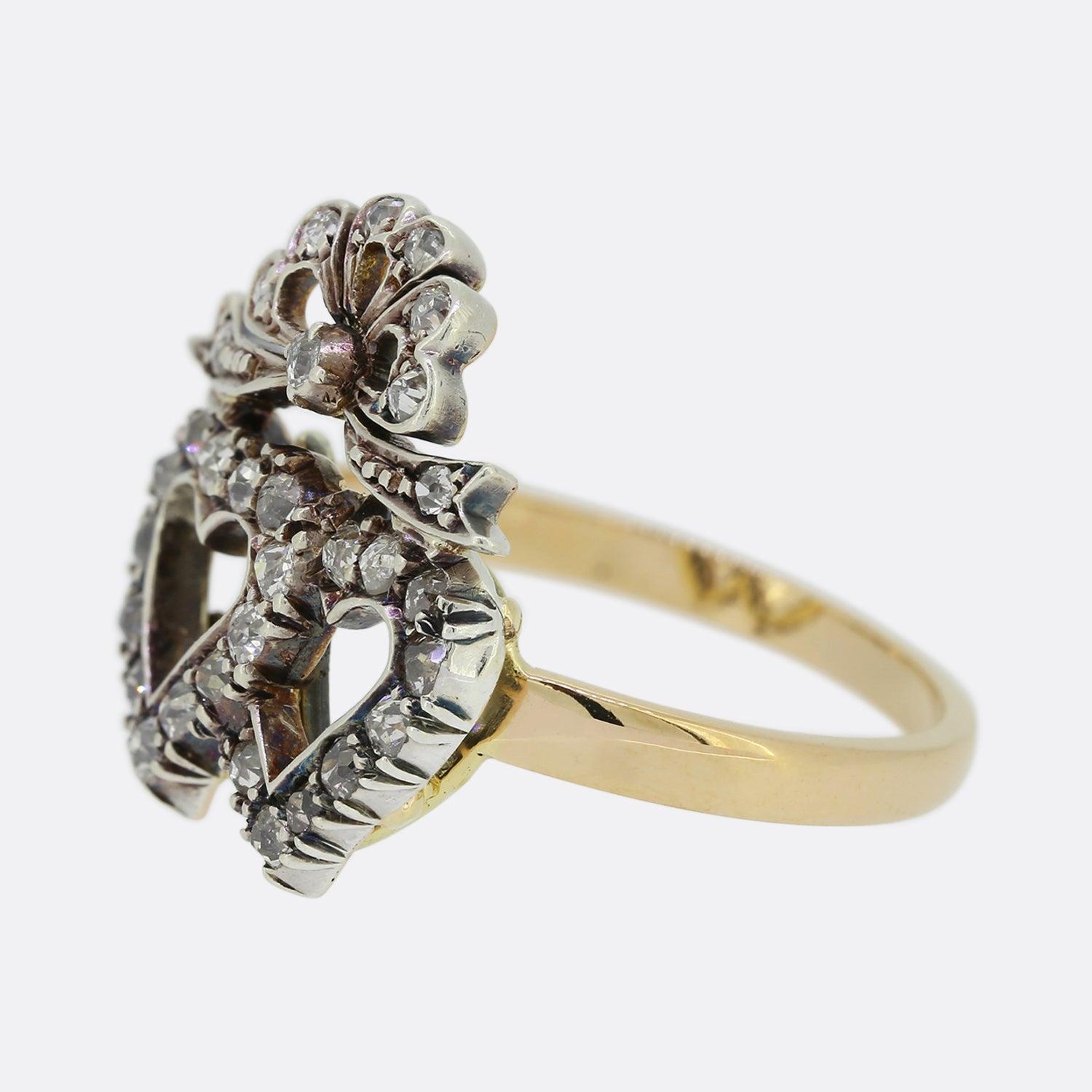 This is a lovely antique double heart ring dating back to the Victorian era. The ring features two open interlocking hearts which have been silver set with a vast array of round old cut diamonds on a yellow gold backing and band. 

Double heart