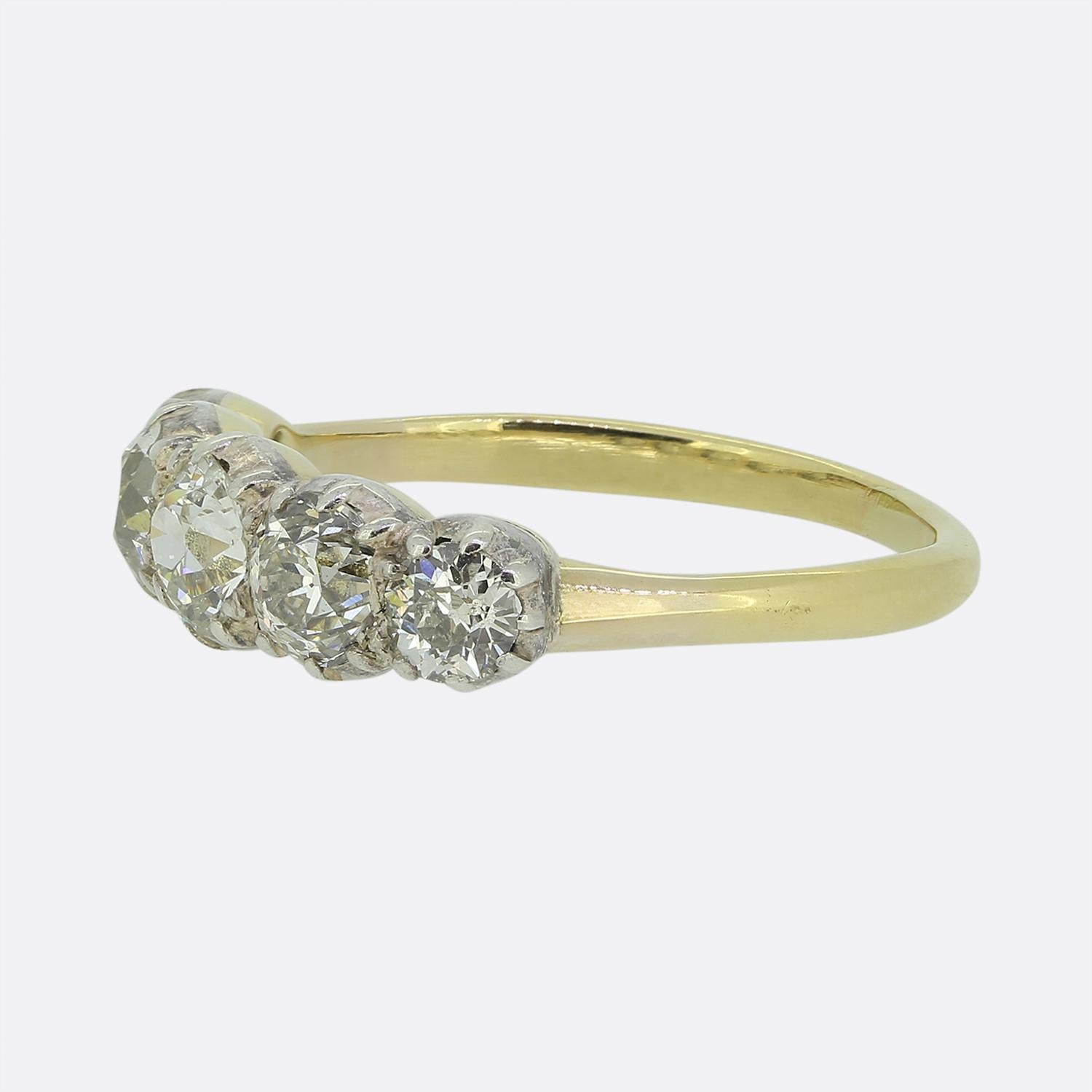 Here we have a refined Victorian ring crafted from 18ct yellow gold. The face features a single row of five round faceted old European cut diamonds, each individually cut-collet set in silver, creating a striking display of brilliance. The gold band