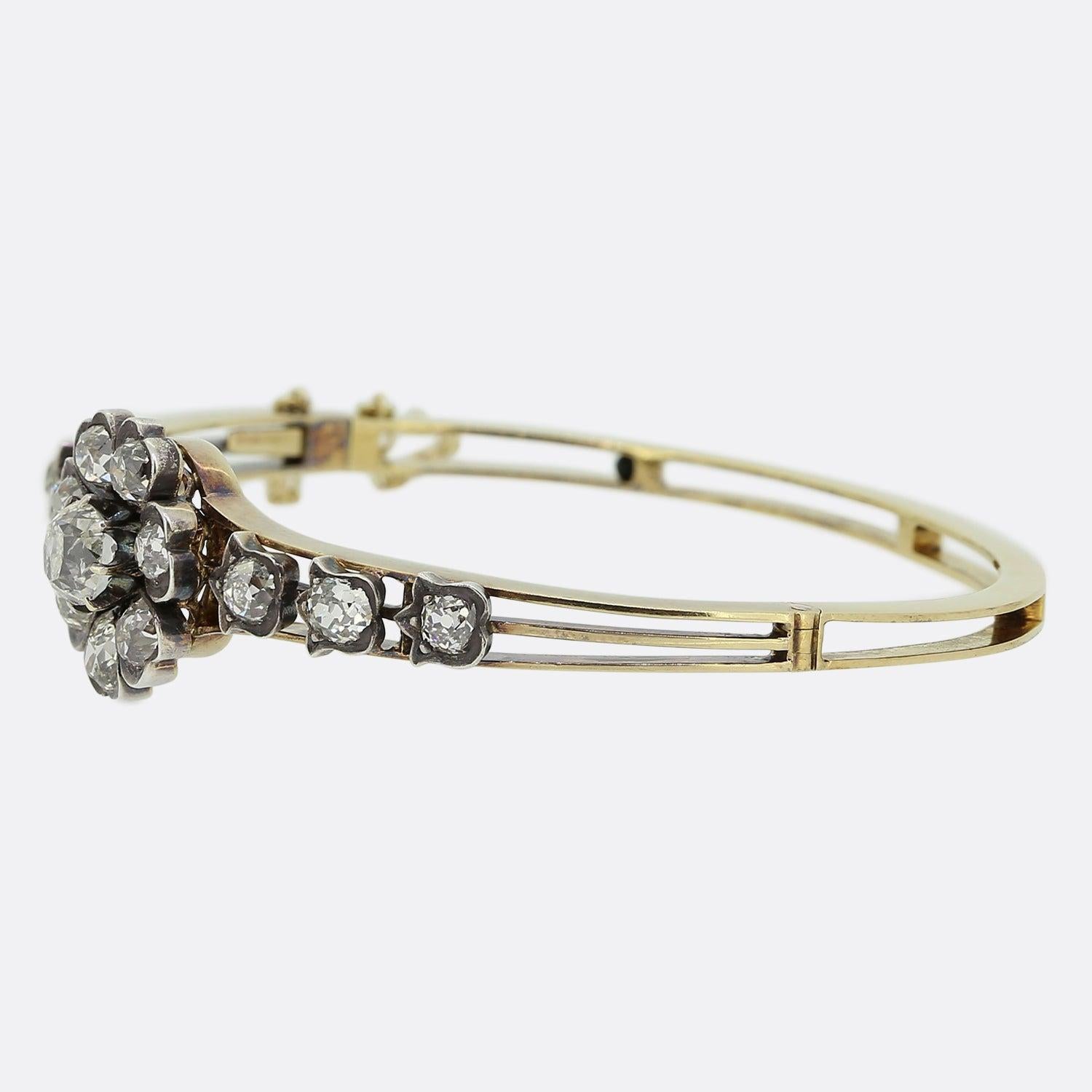 Here we have a marvellous diamond bangle that dates back to the Victorian era. The focal point of the bangle is a stunning chunky 1.15 carat old mine cut diamond that is surrounded by seven well matched old cut diamonds. It has a floral theme and