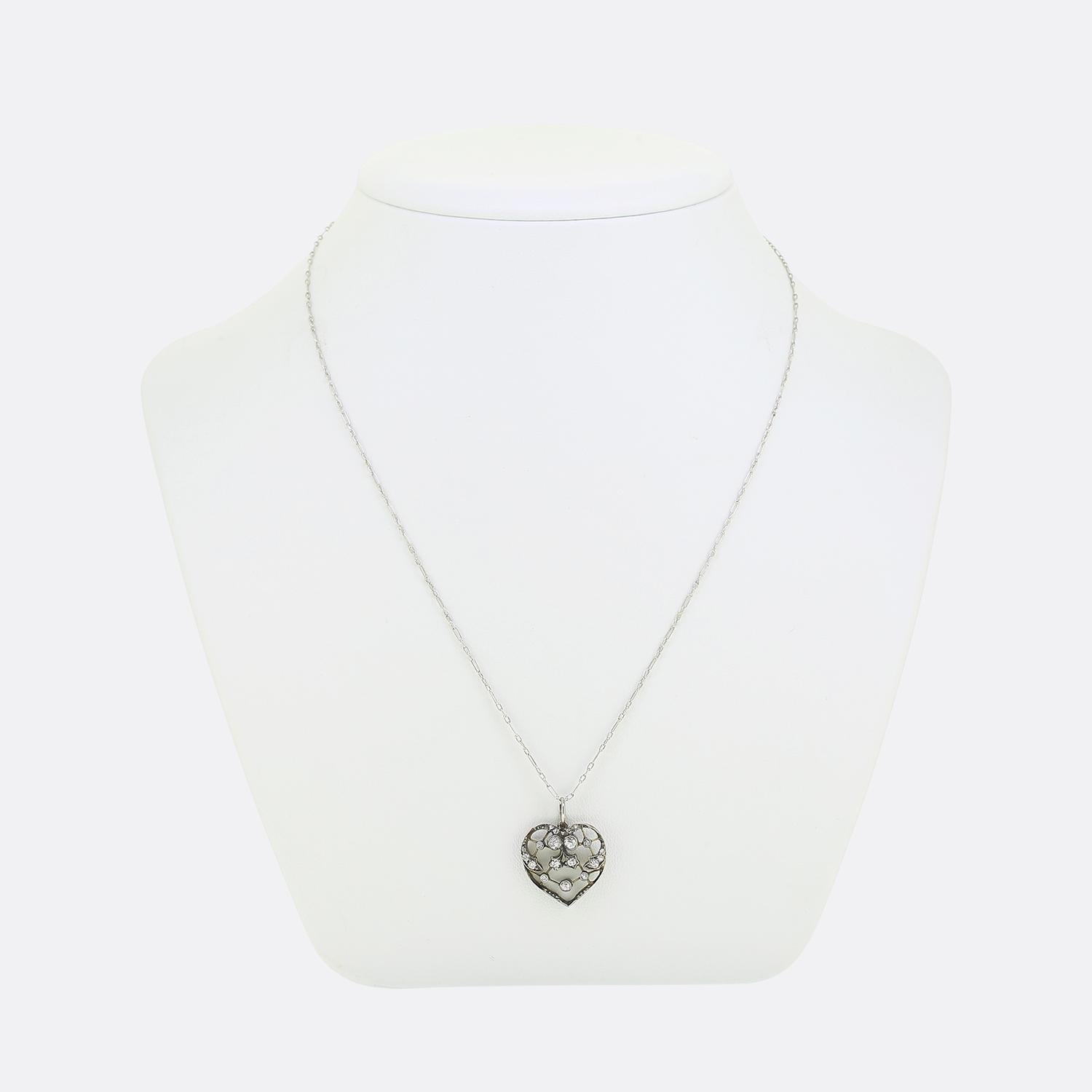 Here we have a charming diamond necklace. This Victorian pendant has been crafted from silver into the shape of a love heart with intricate openwork playing host to an array of round faceted old mine cut diamonds. The design includes star and floral