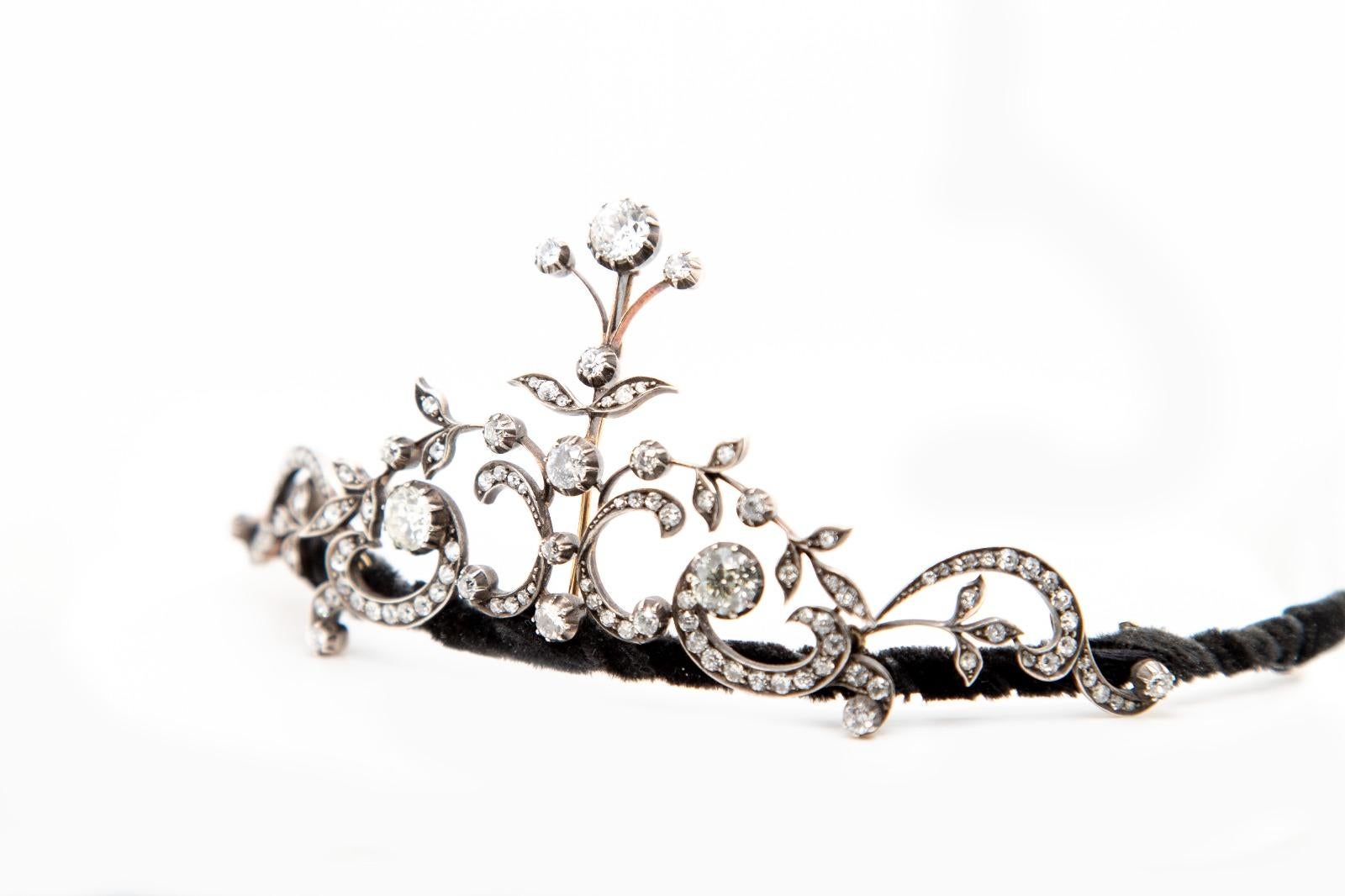A Victorian old cut diamond tiara.

This exquisite, handmade Victorian yellow gold and silver diamond tiara is comprised of a central foliate design, vertically set with round old cut diamonds and a cascade of old cut diamond set openwork floral