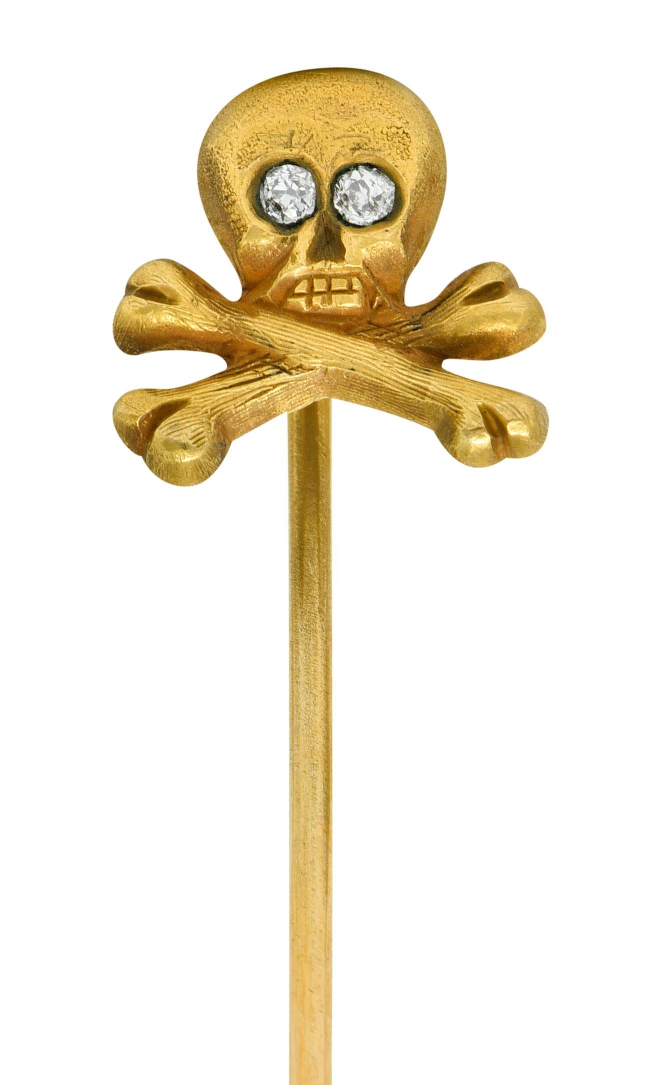 Designed as a grimacing skull with a crossed bone base; matte gold

Accented with old European cut diamond eyes, weighing in total approximately 0.05 carat

Tested as 14 karat gold

Circa: 1890

Head measures: 7/16 x 7/16 inch

Total length: 2 3/8
