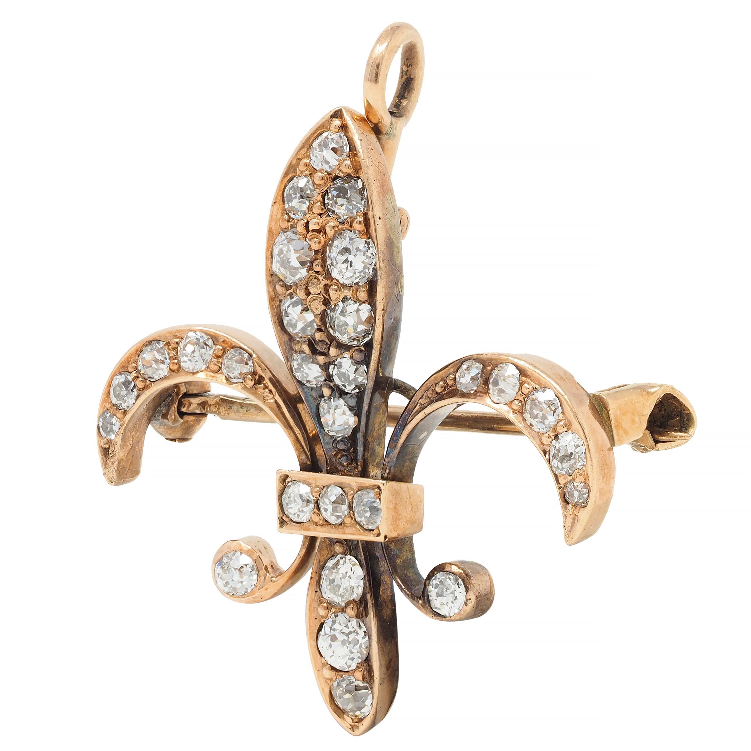 Designed as a stylized fleur-de-lis form bead set with old European cut diamonds
Weighing approximately 0.72 carat total - H/J color with VS2 clarity
Completed by hinged pinstem with locking closure
With hinged optional bale 
Stamped for 10 karat