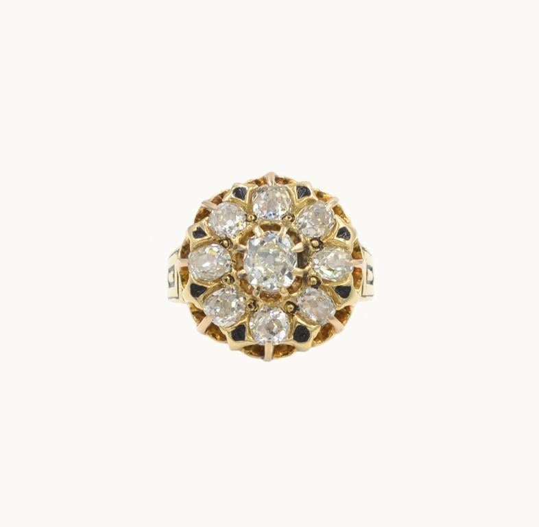 Victorian diamond cluster ring in 18 karat yellow gold with black enamel details. This beautiful ring features 8 Old Mine Cut diamonds that are I-J-K in color and VS-SI2 in clarity.  The center diamond is approximately 0.75 carats with an additional