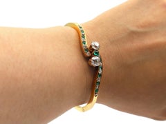 Victorian Old Mine Cut Diamond and Emerald Two Stone Twist Hinged Bangle