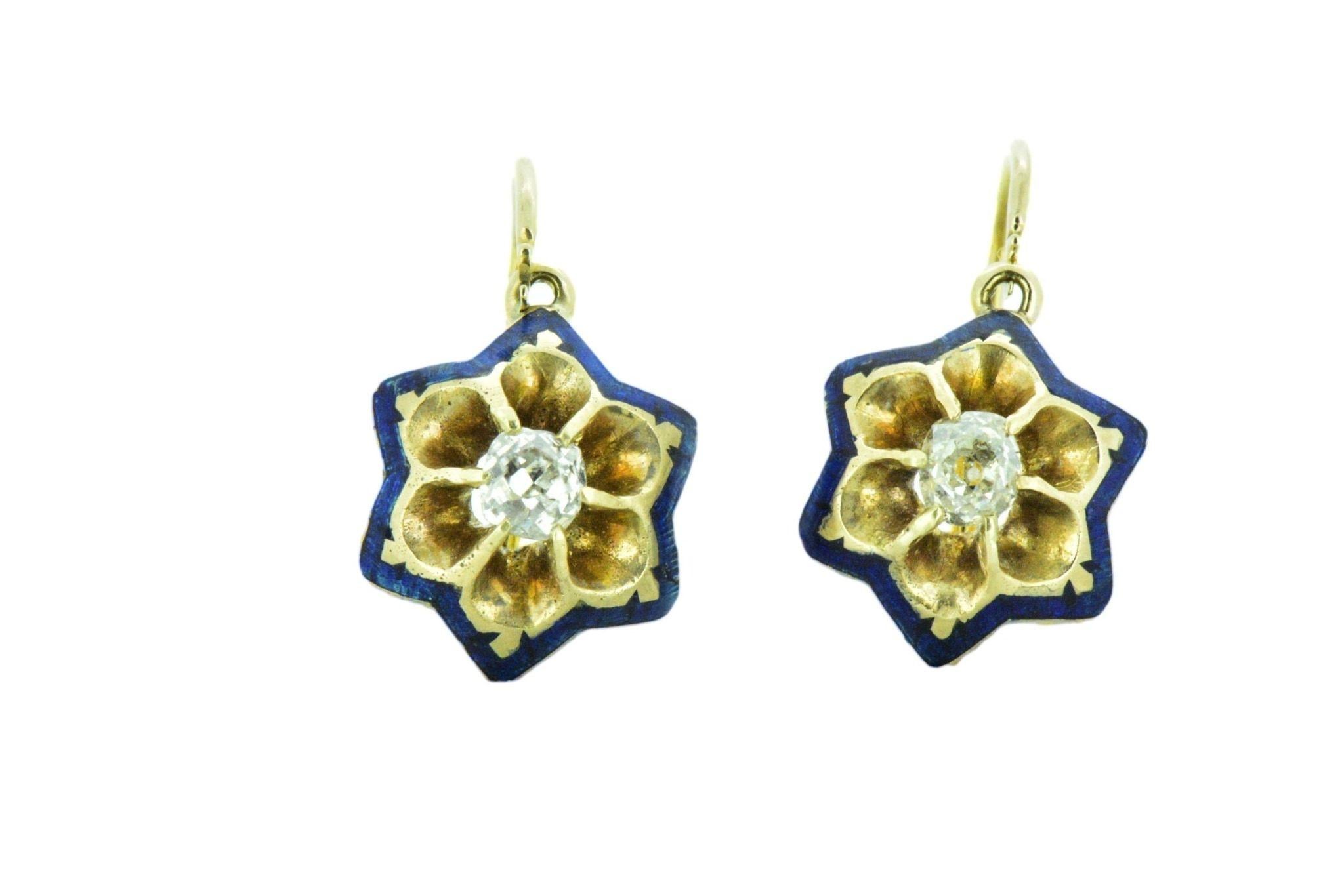 Here is a delightful pair of Victorian enamel and diamond earrings.  Royal blue enamel delicately accents the edges of the star earrings. Each earring is set with an old mine diamond .36 carat total weight. The old mine diamonds are eye clean and