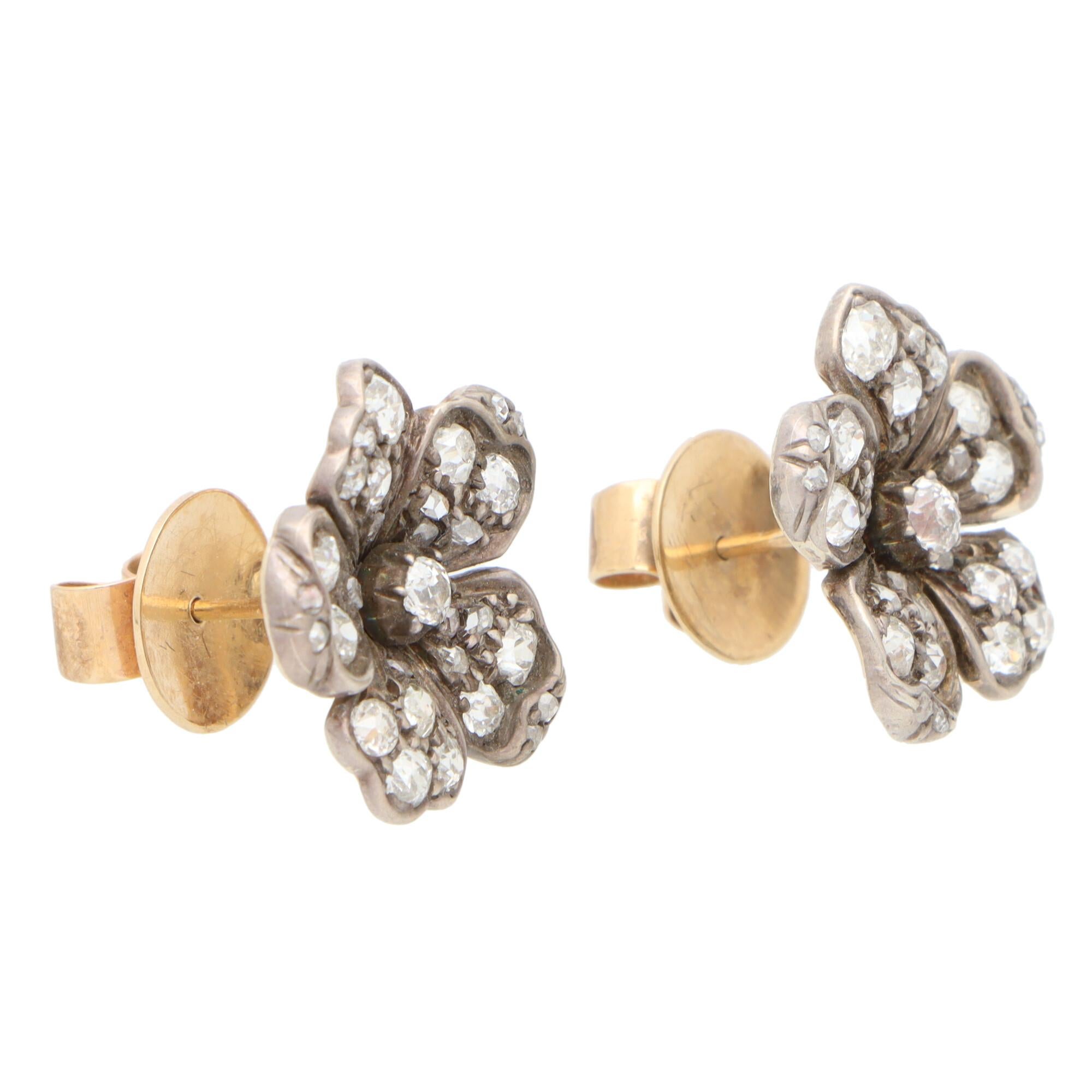 A truly beautiful pair of Victorian diamond floral cluster earrings set in silver on gold.

Set in the iconic Victorian silver on gold setting; each earring depicts a delicate looking floral motif and are set with a mixture of rose and old mine cut