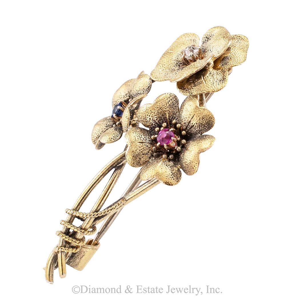 Victorian old mine-cut diamond ruby sapphire and gold posy brooch circa 1890.

DETAILS:
GEMSTONES:  one of each round ruby and sapphire.
DIAMONDS:  one old mine-cut diamond weighing approximately 0.05 carat.

METAL:  14-karat yellow