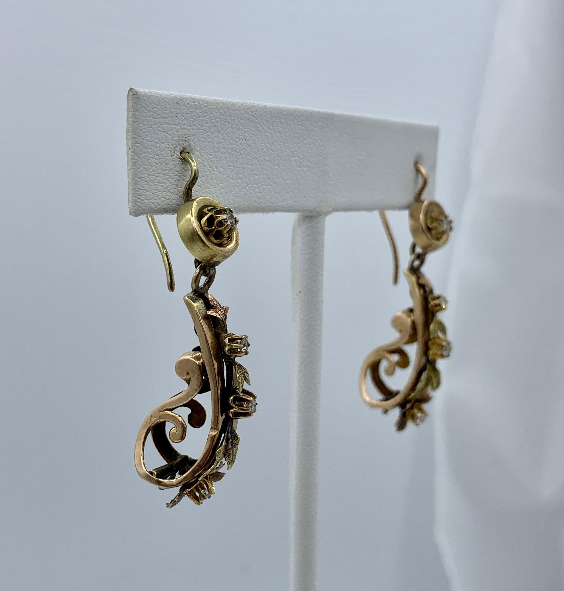 This is rare pair of early Old Mine Cut Diamond Antique Victorian flower and leaf motif Dangle Drop Earrings in 14 Karat Gold.   These antique earrings are of the highest quality.  They have extraordinary design with applied leaves leading to a