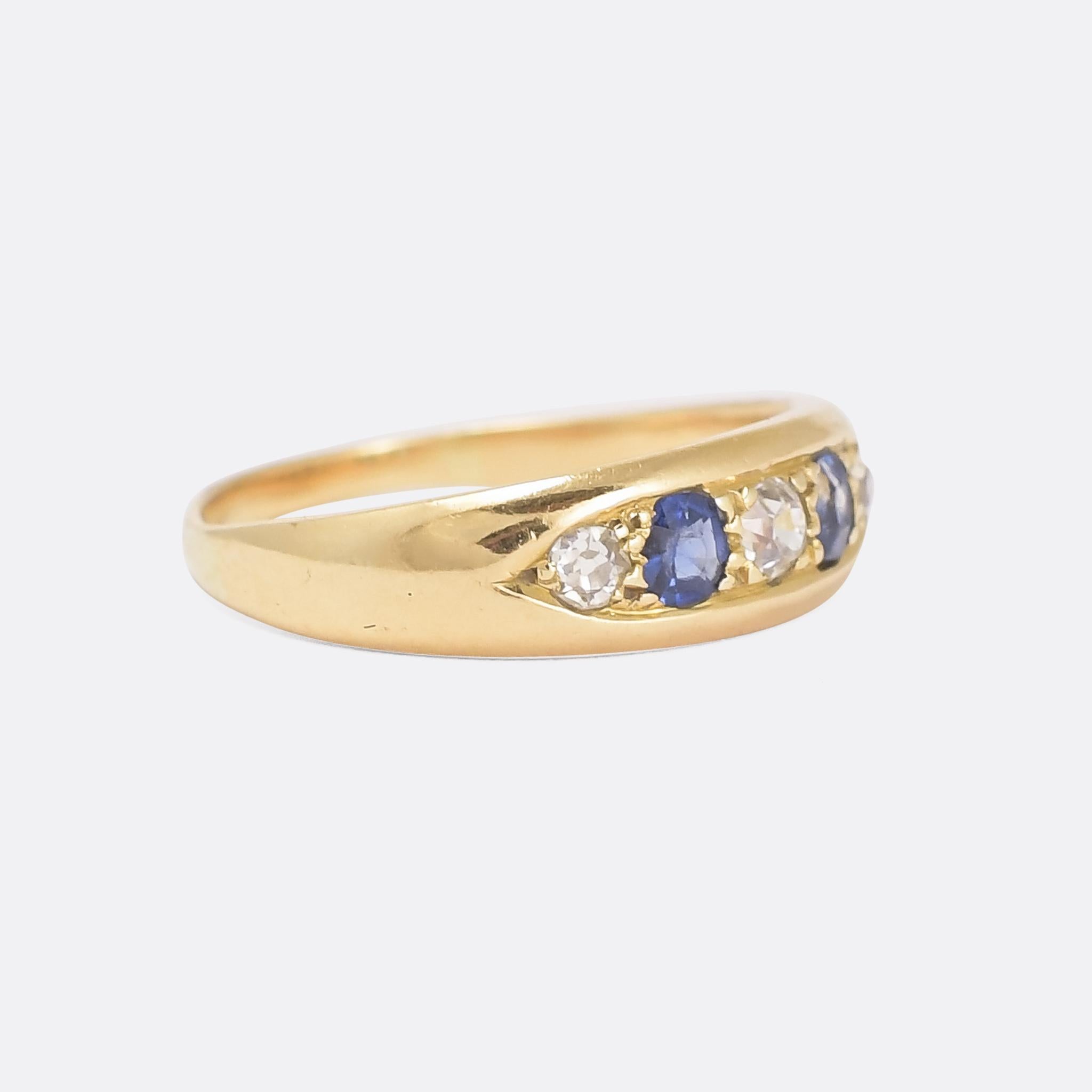 A cool antique gypsy band set with alternating blue sapphires and old mine cut diamonds. It dates from the late Victorian period, circa 1890, with a sleek profile that makes it ideal for stacking. Crafted in 15 karat gold.

STONES 
Old Mine Cut
