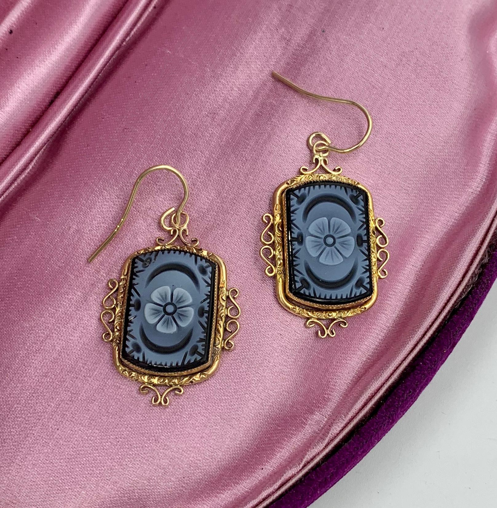A spectacular pair of Antique Victorian hardstone Flower Cameo Pendant Dangle Drop Earrings in 14 Karat Gold.   These stunning earrings are of the highest quality.  They have extraordinary hand carved Cameos in Onyx with a central flower with a