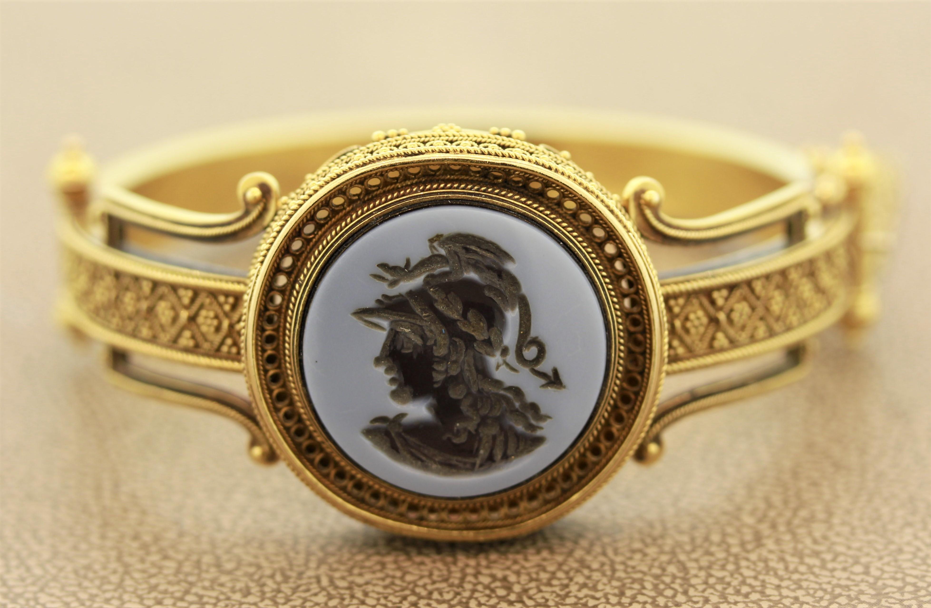 A classic piece from the end of the 19th century, this Victorian treasure features a natural onyx cameo of a regal statesman. The gold work is second to none with its intricate details and filigree work. Made in 14k yellow gold and in original