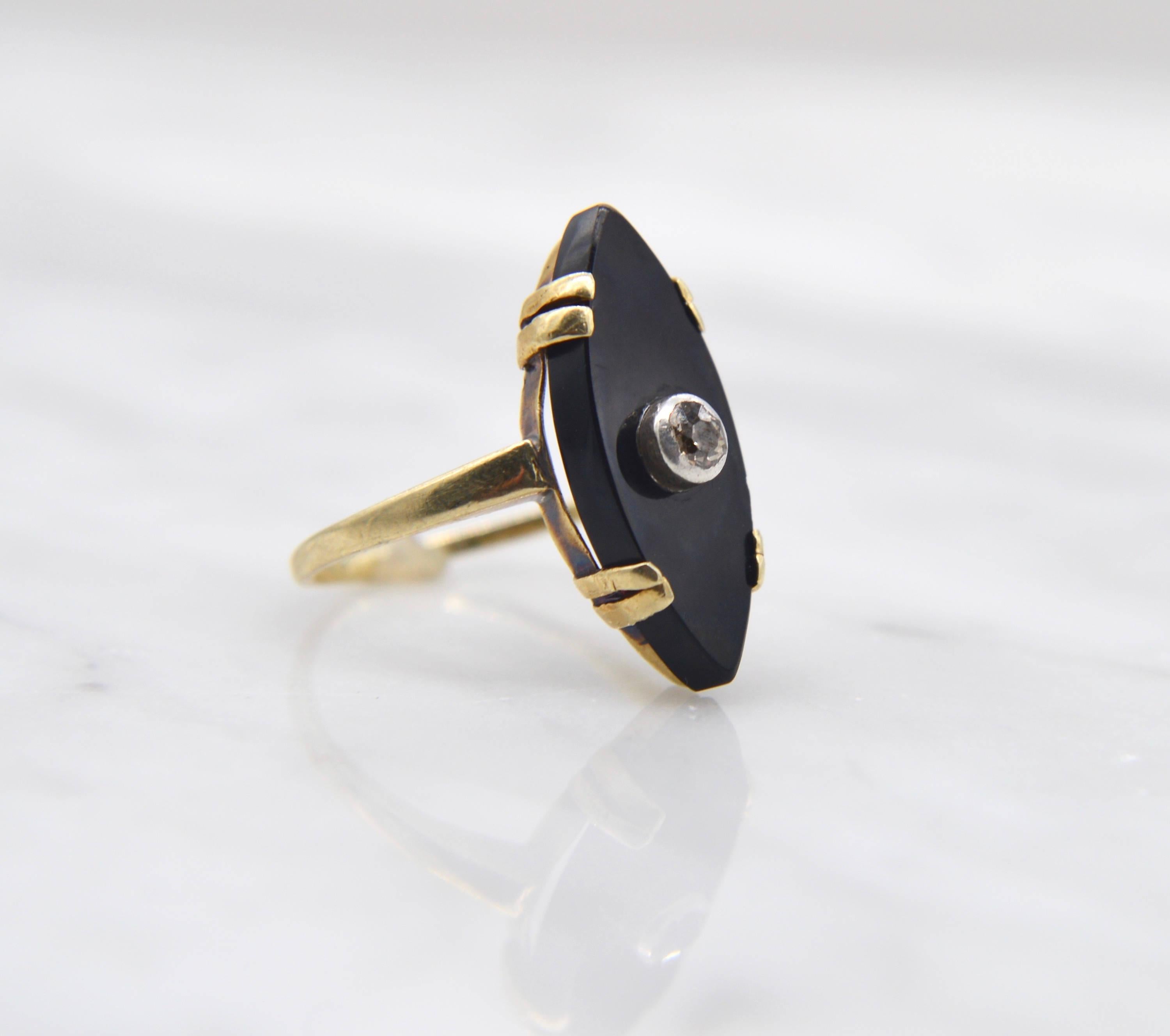 Spectacular Victorian era antique circa 1880s onyx navette ring with an amazing old European cut diamond in 14K yellow gold. Size 5.5 and can be resized by a jeweler. In very good condition. Onyx measures 20x7mm, the sparkling white diamond with no