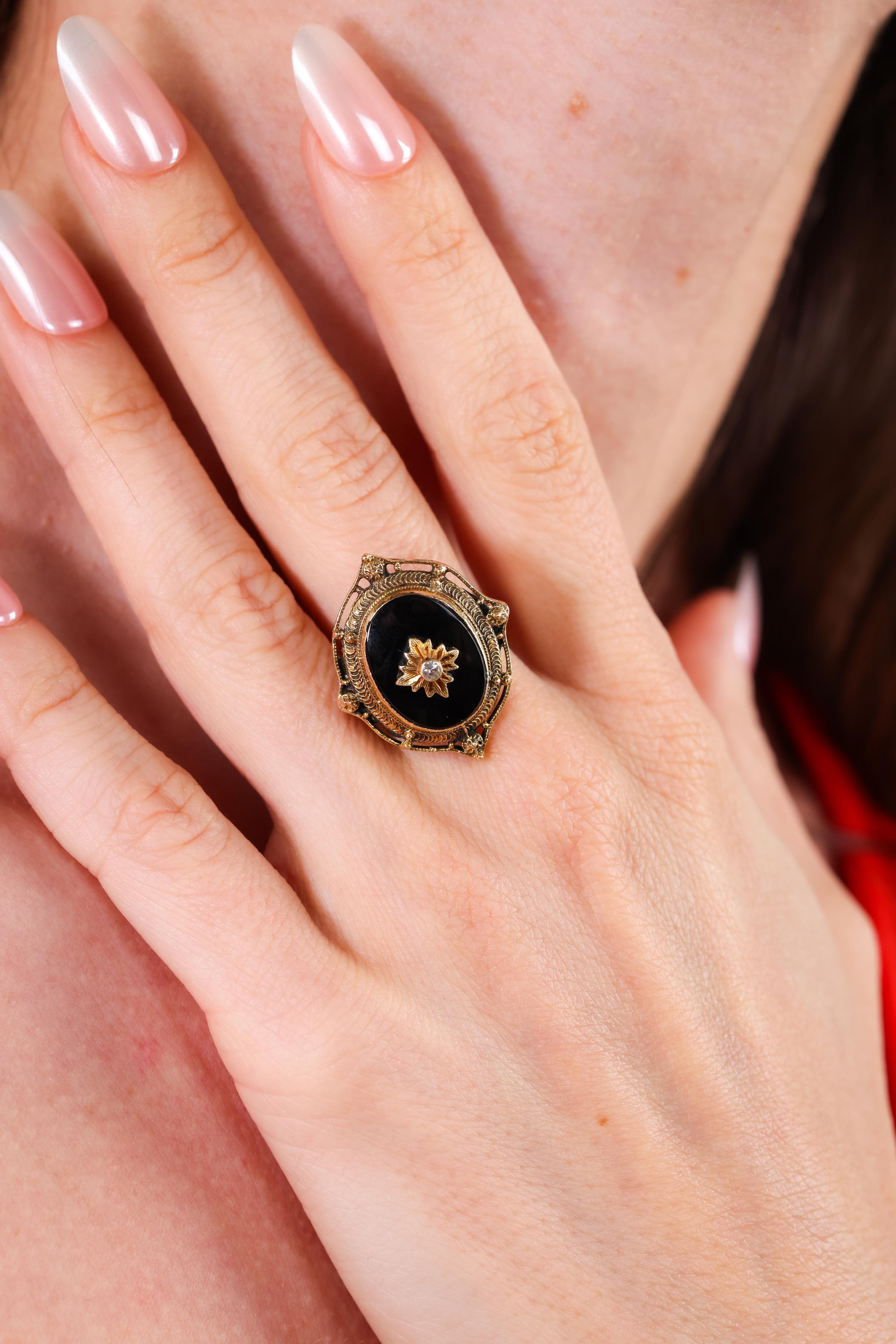 Center Stone: Onyx
Accent Stone: Diamond
Cut: Old European
Weight: 0.02 carat approximately 
Color: L-M
Clarity: SI
Metal: 14k yellow gold
Era: Victorian
Circa: 1890s
Size: 6-1/4 and can be resized 
Gram weight: 6.7
 
Transport yourself to the