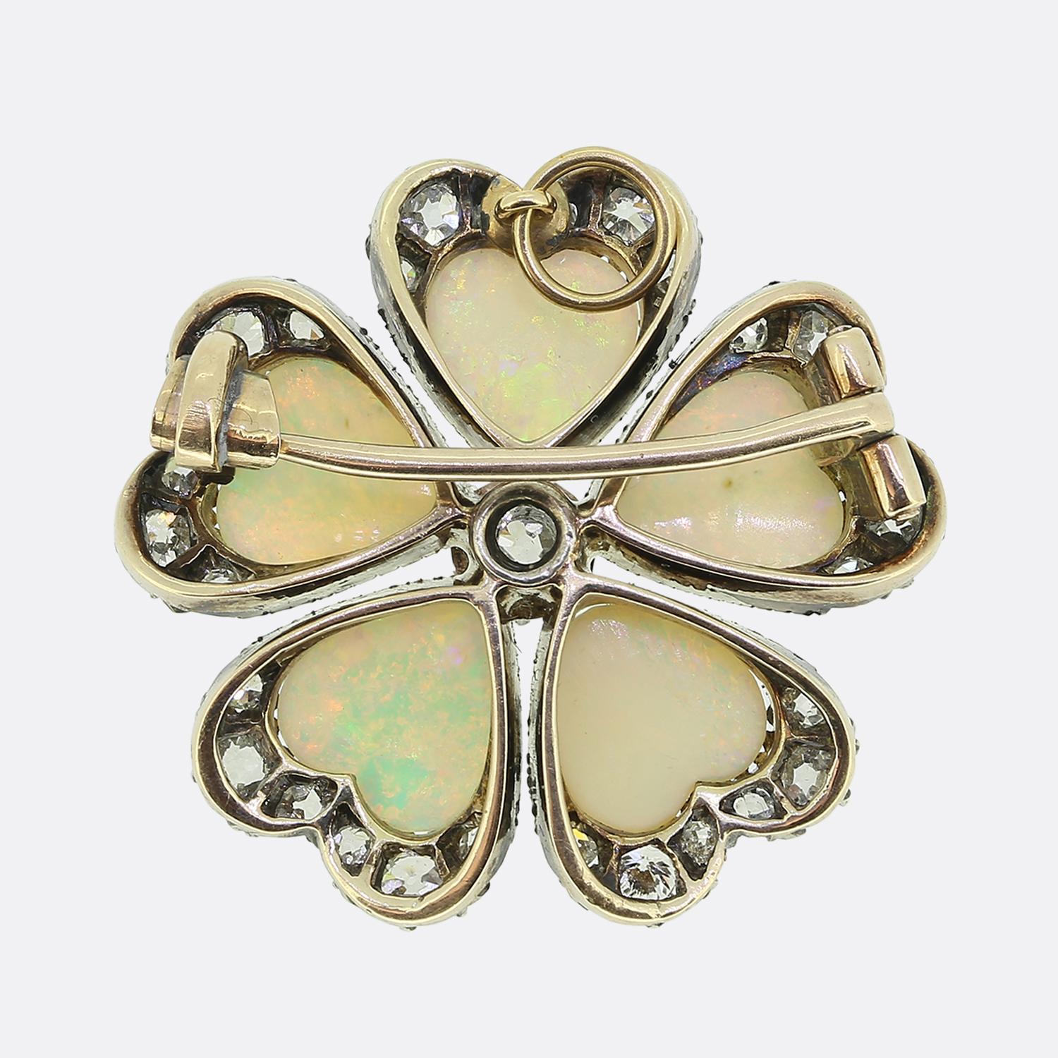 Here we have a marvellous brooch come pendant taken from the Victorian period. This antique piece has been crafted from 18ct yellow gold into a multilayered floral design with each petal playing host to a resplendent heart-shaped white opal