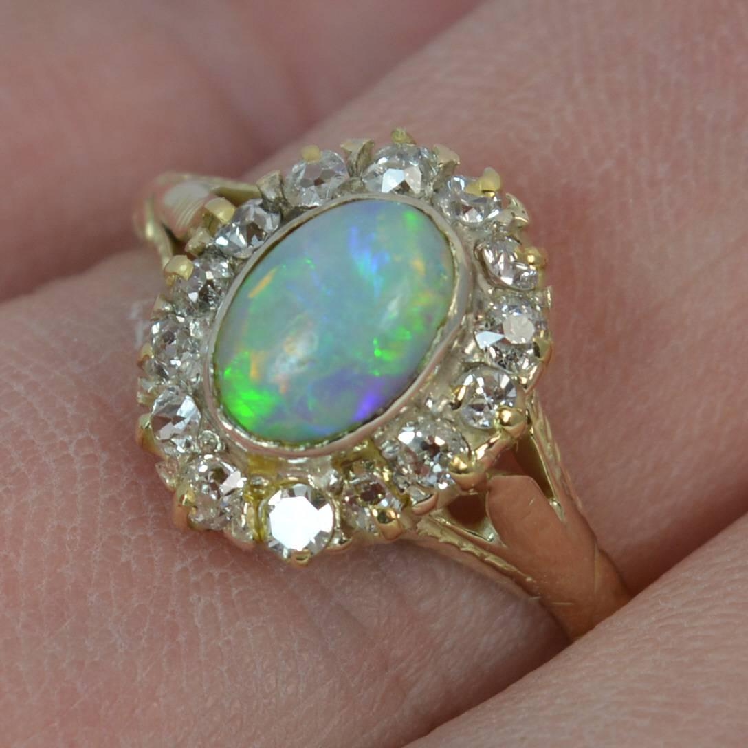 
A beautiful Victorian period natural opal and diamond ring.

Designed with a natural oval opal to centre, 5.1mm x 7.1mm approx with a lovely blue green undertone and flashes of all colours.

​The opal has a full surround of 14 old cut