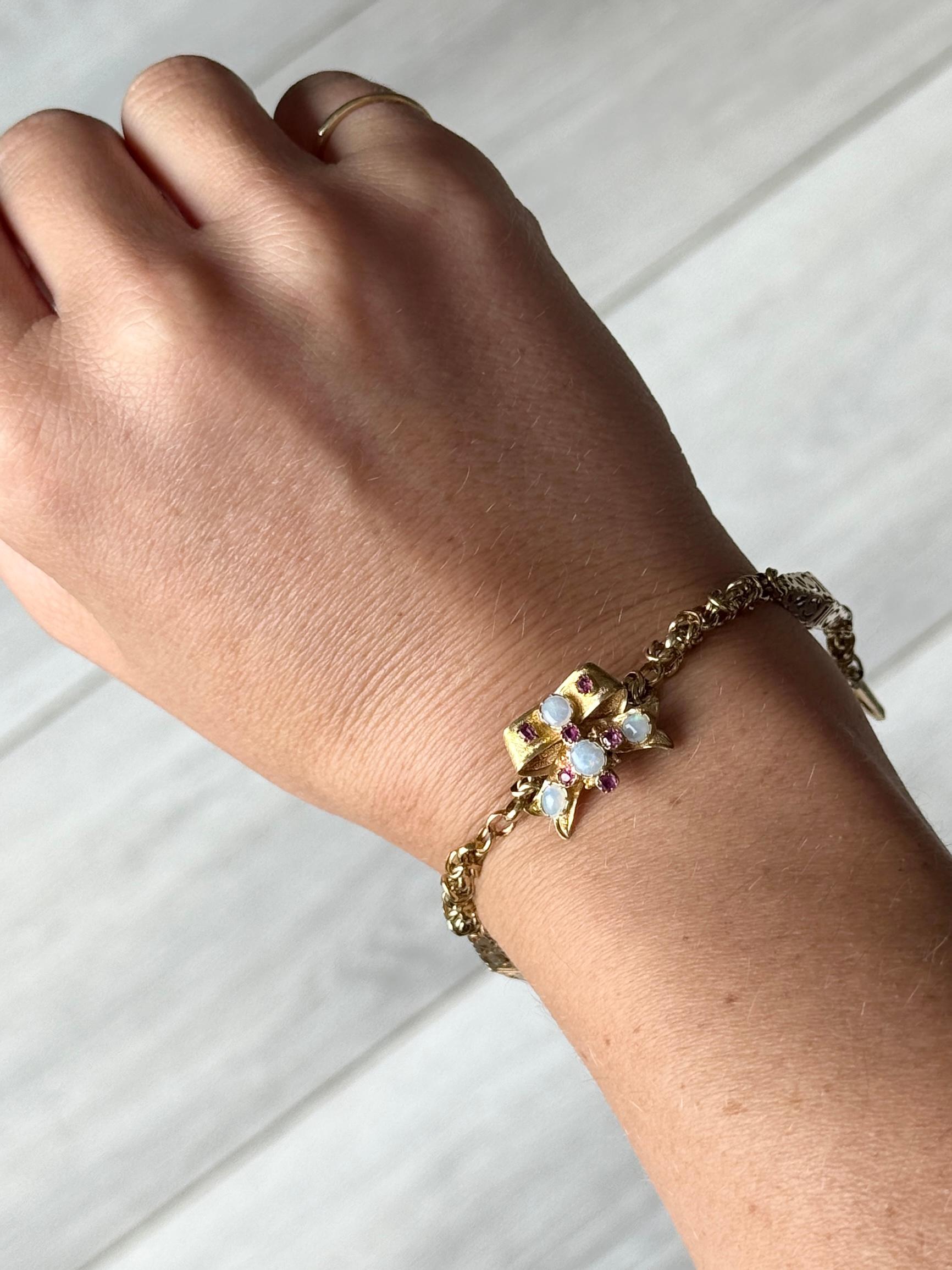 This gorgeous bracelet is modelled in 9carat gold and has plenty of details. The panel is set with four opals and six rubies. The rubies measure 4pts each.

Length: 19.5cm
Panel Dimensions: 19x15mm

Weight: 9g
