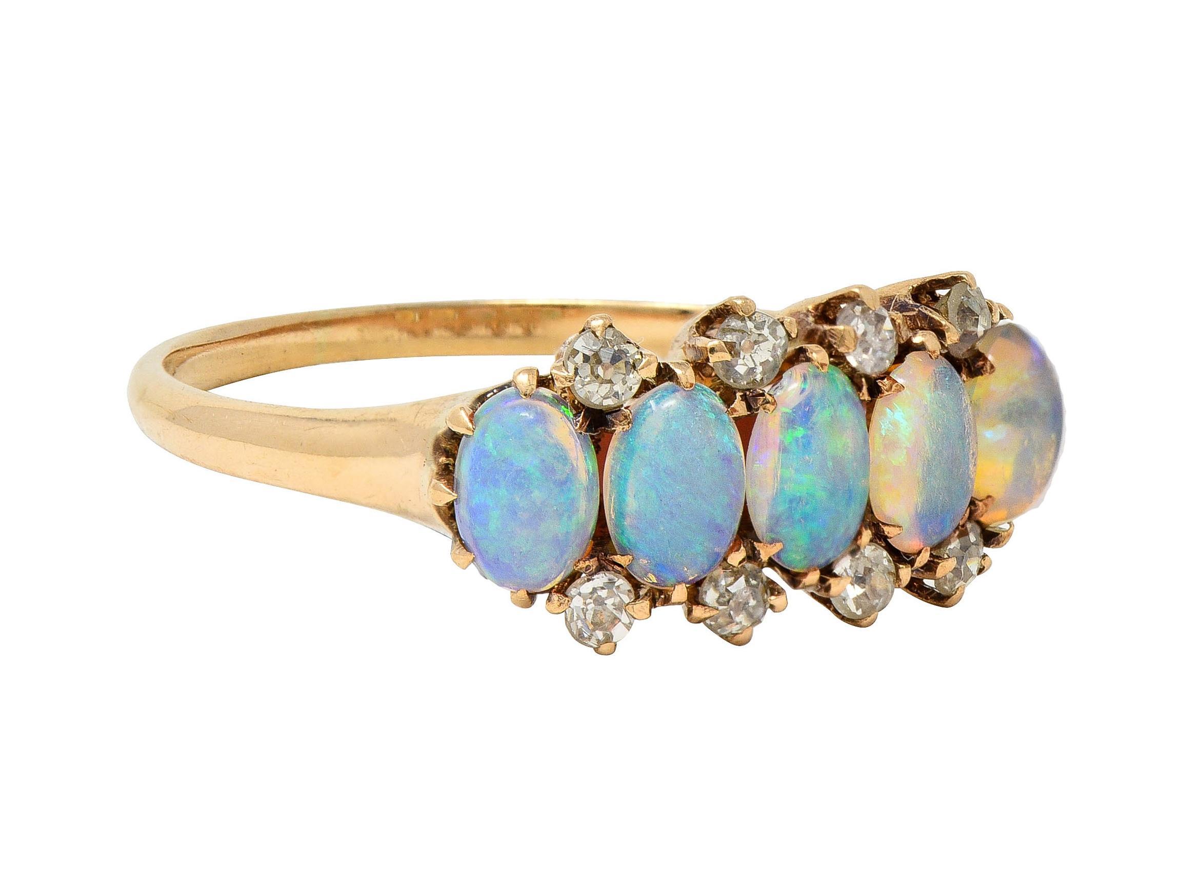 Featuring five oval-shaped opal cabochons, each measuring 3.0 x 4.5 mm
Translucent white in body color with spectral play-of-color - prong set in rows
Accented by rows of prong set old single cut diamonds
Weighing approximately 0.24 carat total -