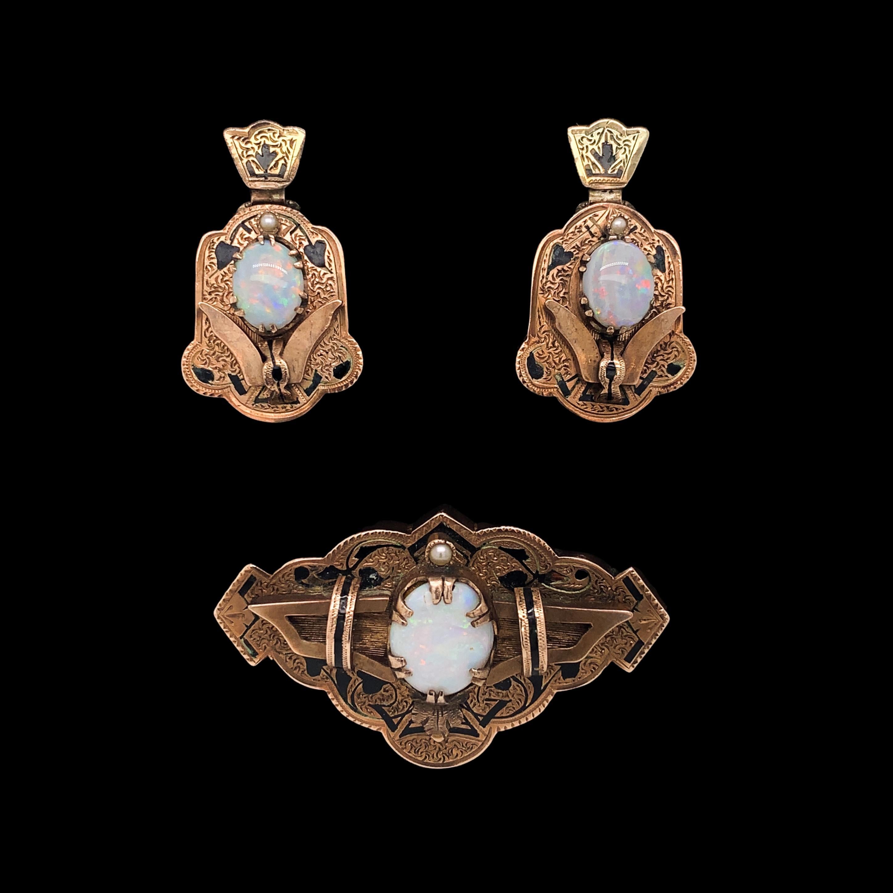 Victorian demi parure 14K rosy yellow gold set with opal pin and earrings. The Australian white opal have multi-color fire including red play of color. The pin and earring set is decorated with Taille d'épargne, or black enamel tracery. The earrings