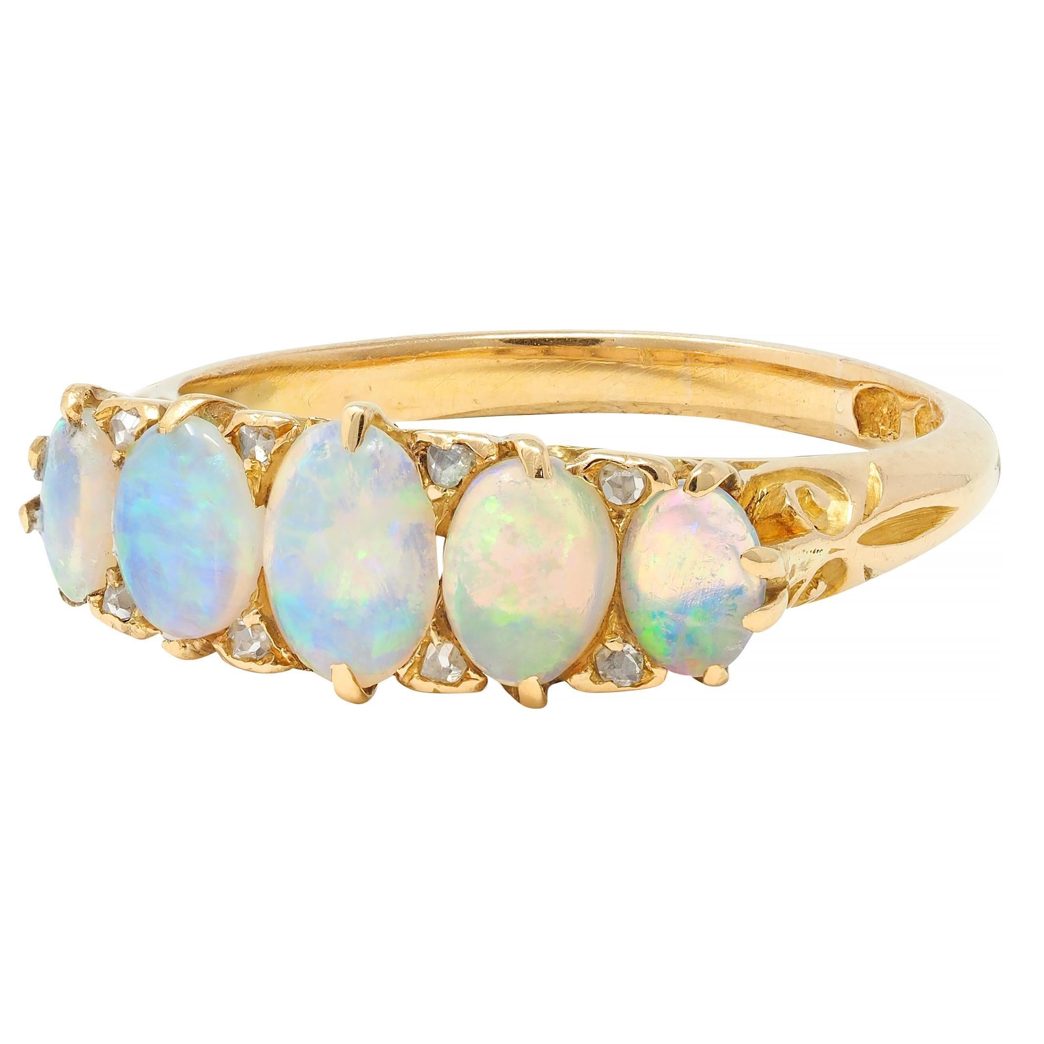 Featuring five oval-shaped opal cabochons ranging in size from 3.0 x 4.0 to 4.0 x 6.0 mm 
Translucent white in body color with strong spectral play-of-color 
Prong set and accented by bead set single-cut diamonds 
Weighing approximately 0.08 carat