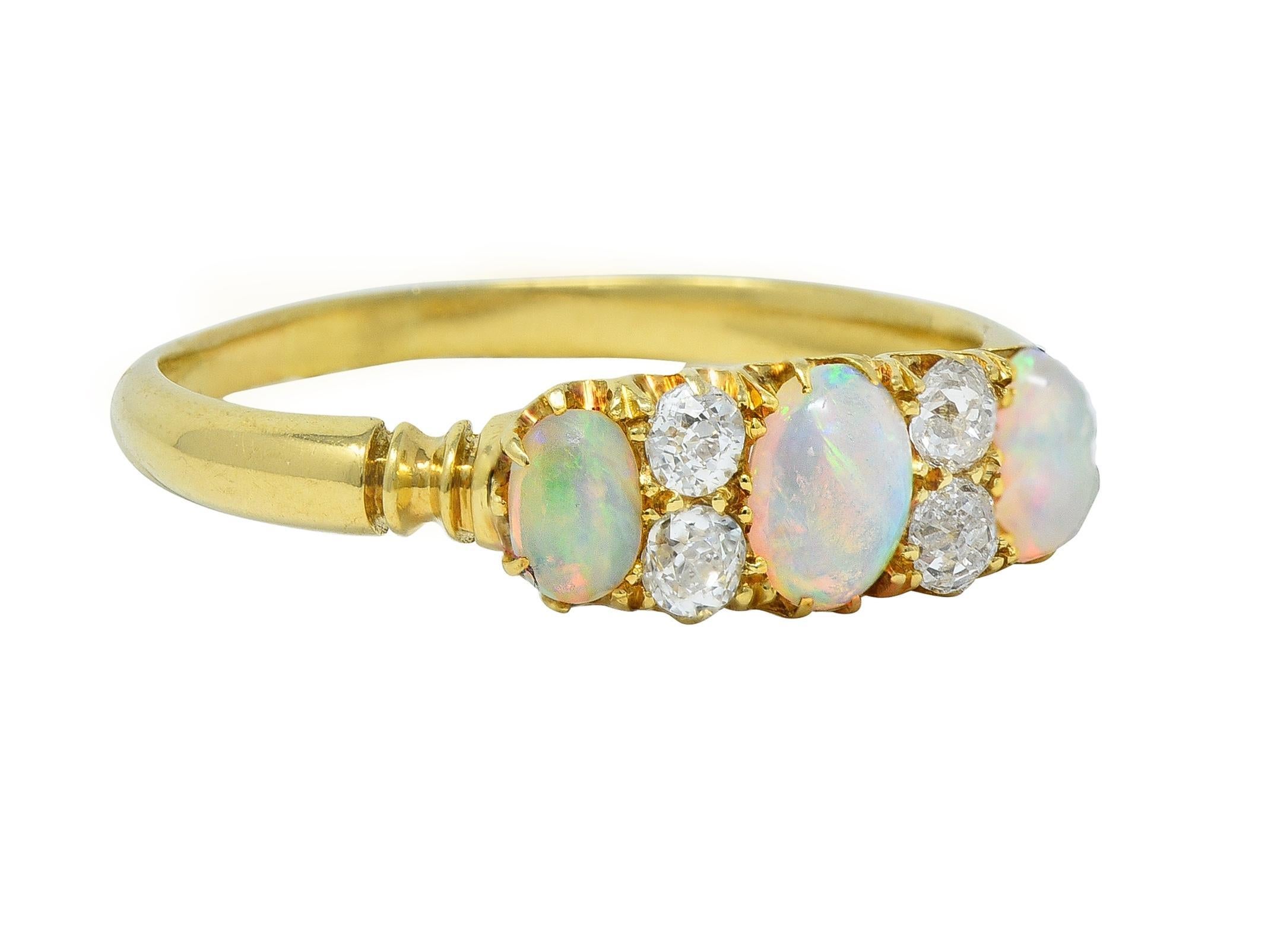 Featuring three oval-shaped opal cabochons prong set east to west
Graduated and ranging in size from 2.5 4.5 mm to 3.5 x 5.0 mm 
Translucent white in body color with spectral play-of-color
Accented by old mine cut diamonds prong set in