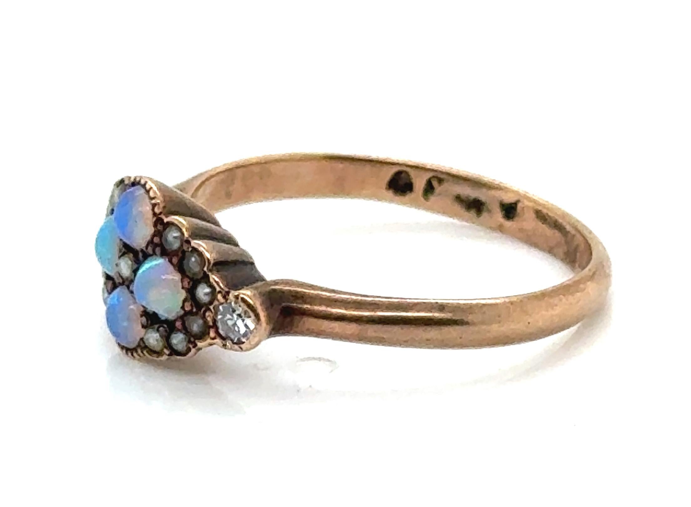Genuine Original Antique from the 1870's-1880's Victorian Opal Diamond Ring Vintage 14K 


Featuring Four Genuine Natural Round Cabochon Opal Gemstones

Studded With Silver Seed Pearls

Genuine Antique Single Cut Diamond to Either Side

Trademarked