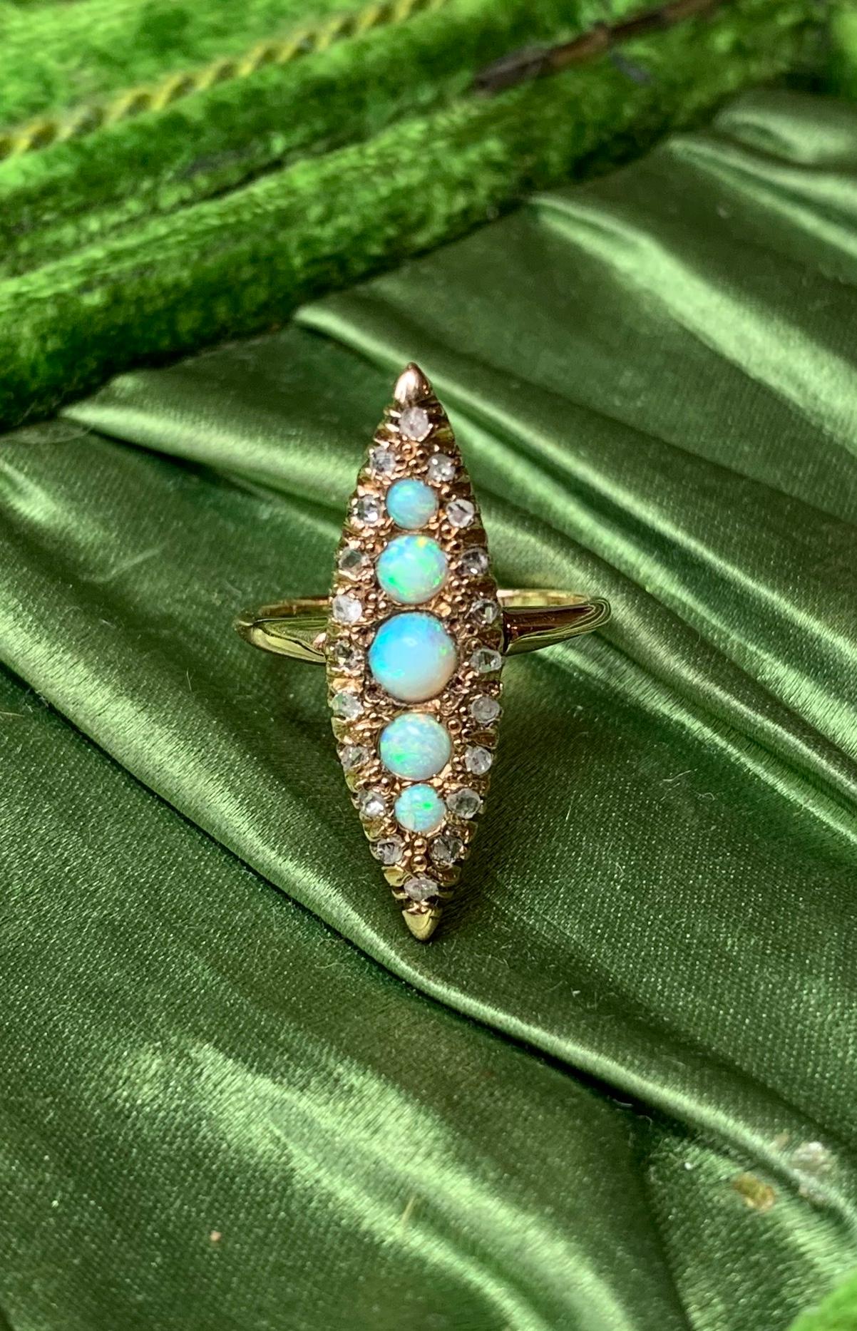 An Antique Victorian - Edwardian Ring with five gorgeous natural round Opals of incredible color and stunning beauty. The five Opal gems are surrounded by sparkling antique Rose Cut Diamonds. This is the combination everyone dreams of!  The jewels