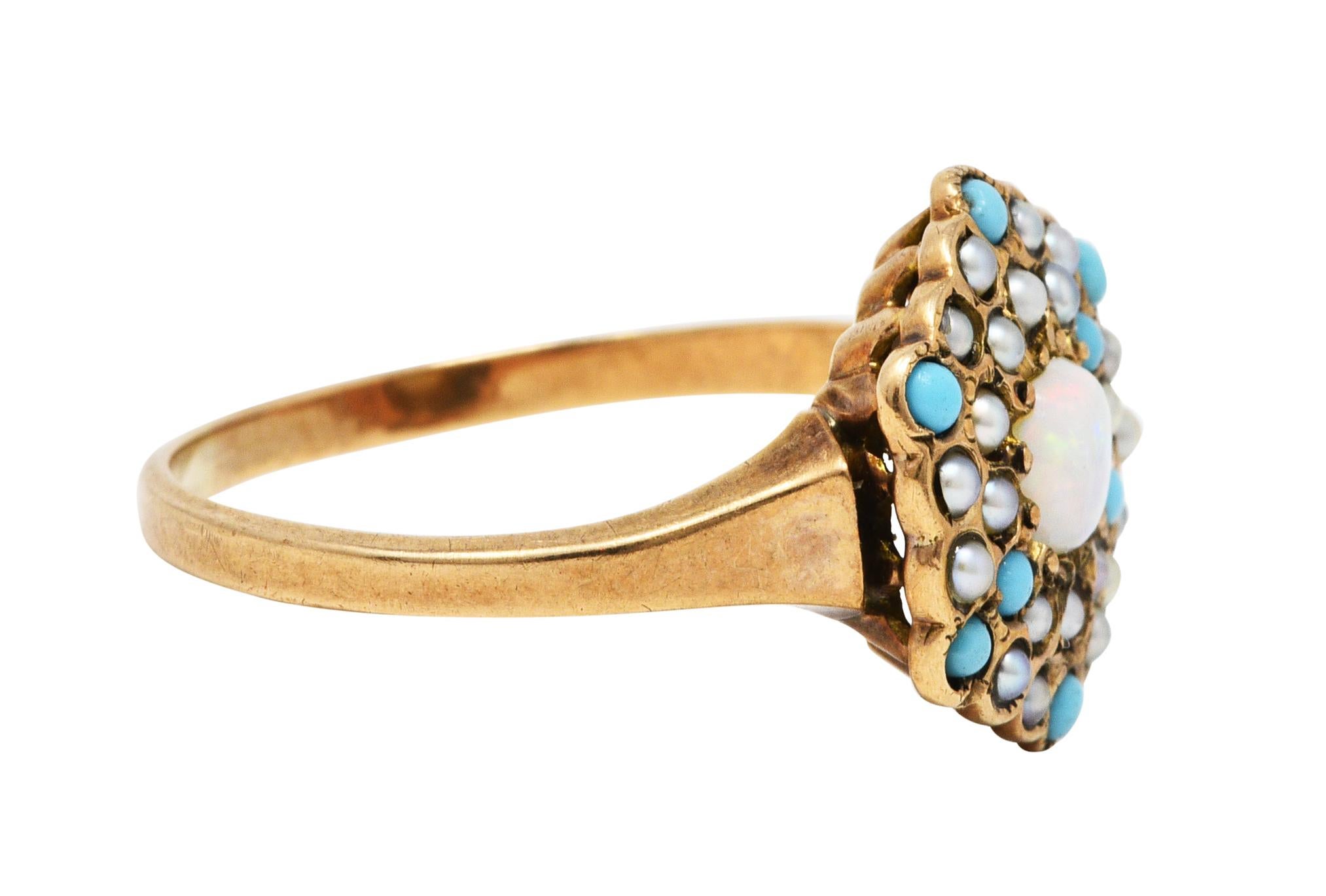 Cluster ring centers a 4.0 mm round opal cabochon

White in body color with strong spectral play-of-color with broad yellow/green flash

Surrounded by round natural freshwater seed pearls and turquoise cabochons

Radiating outward in a burst
