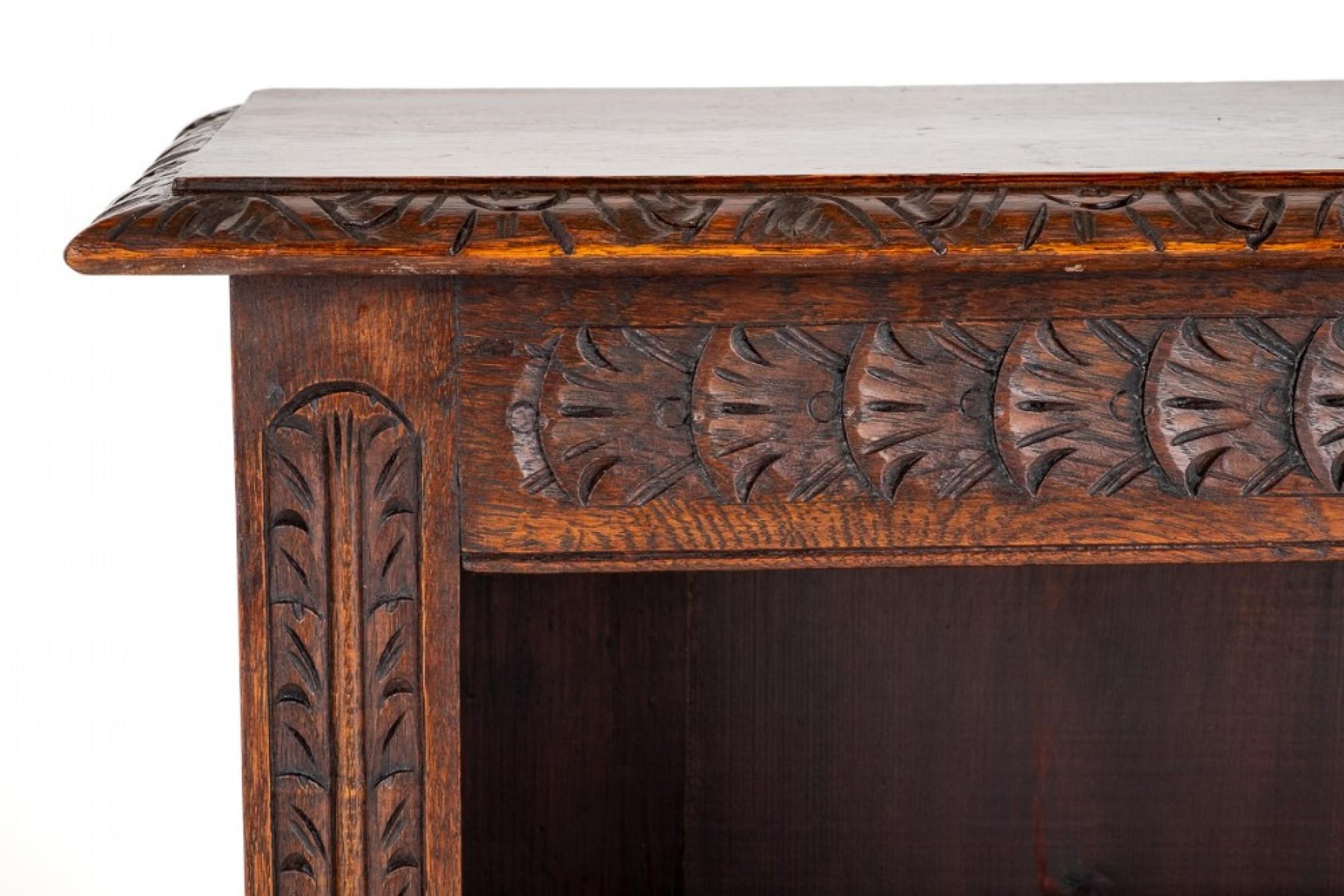 Carved Oak open bookcase 
Standing Upon Inset Bracket Feet.
circa 1900
Featuring 2 adjustable shelves.
The Shelves are Flanked By Carved Pilasters.
The Top of The Bookcase Having a Carved Frieze and Carved Mouldings.