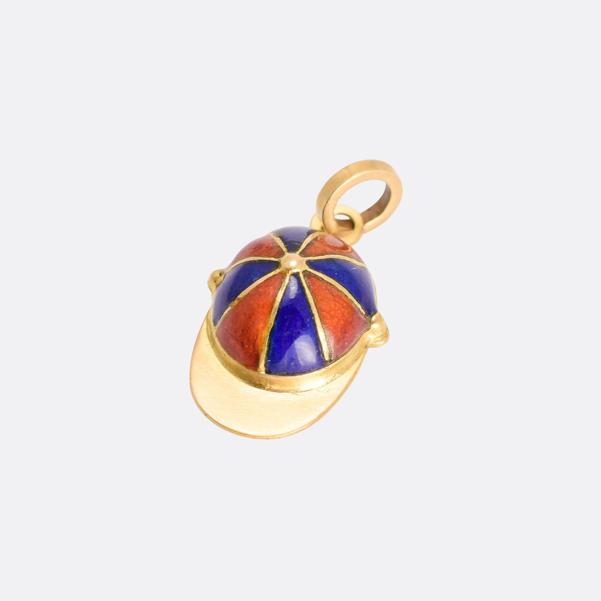 An especially good quality Victorian charm pendant modelled as a jockey's cap. It's crafted in 18k yellow gold and finished in orange and blue enamel - dating from the late 19th Century, circa 1890.

MEASUREMENTS 
18.6 x 11.8mm (not including