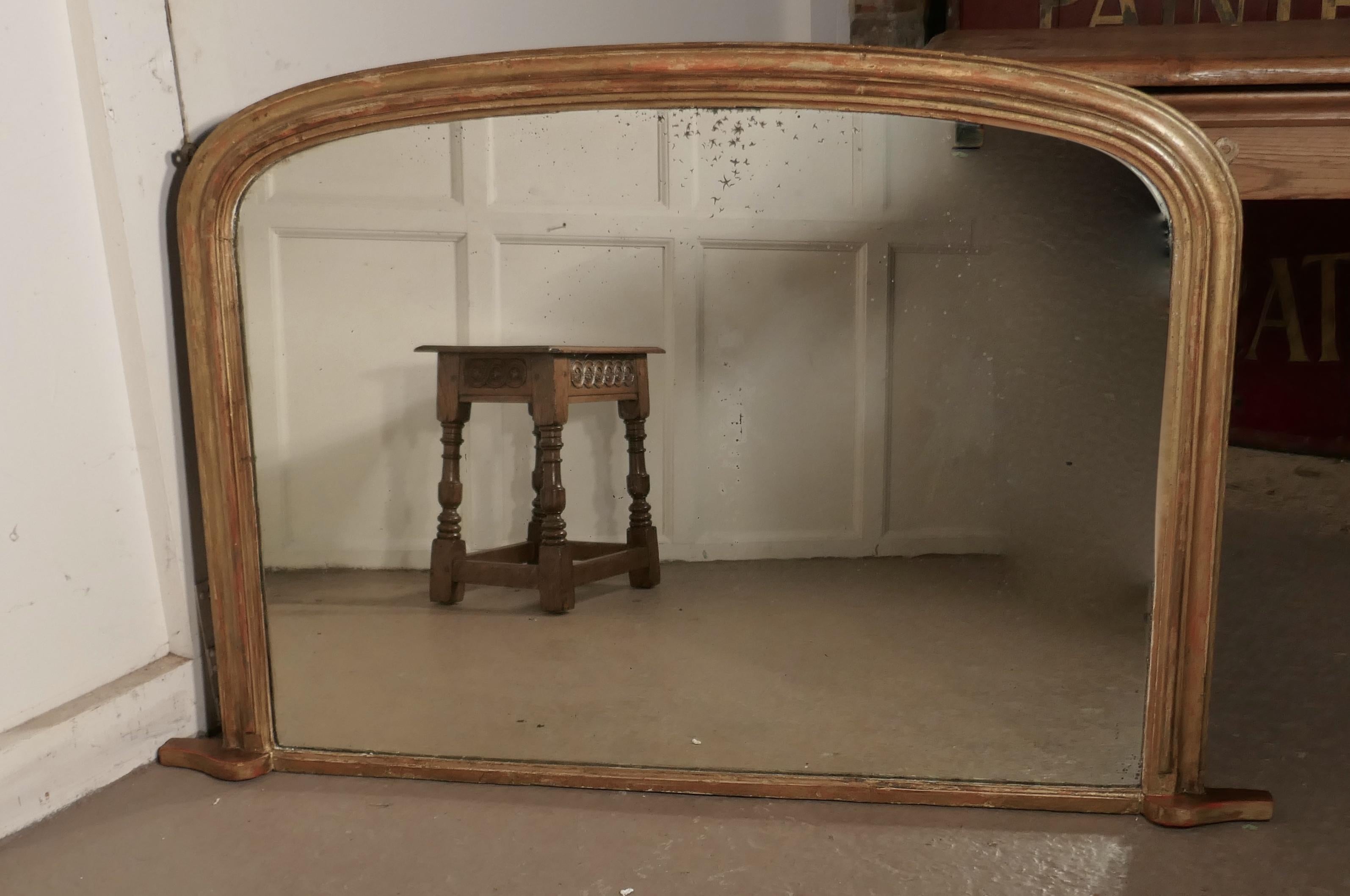 Victorian original shabby look gold overmantel mirror

Victorian shabby gilt overmantel mirror
This is a charming and genuine piece of shabby chic furnishing, the frame is in gold with some of the red undercoat showing through
The mirror is in